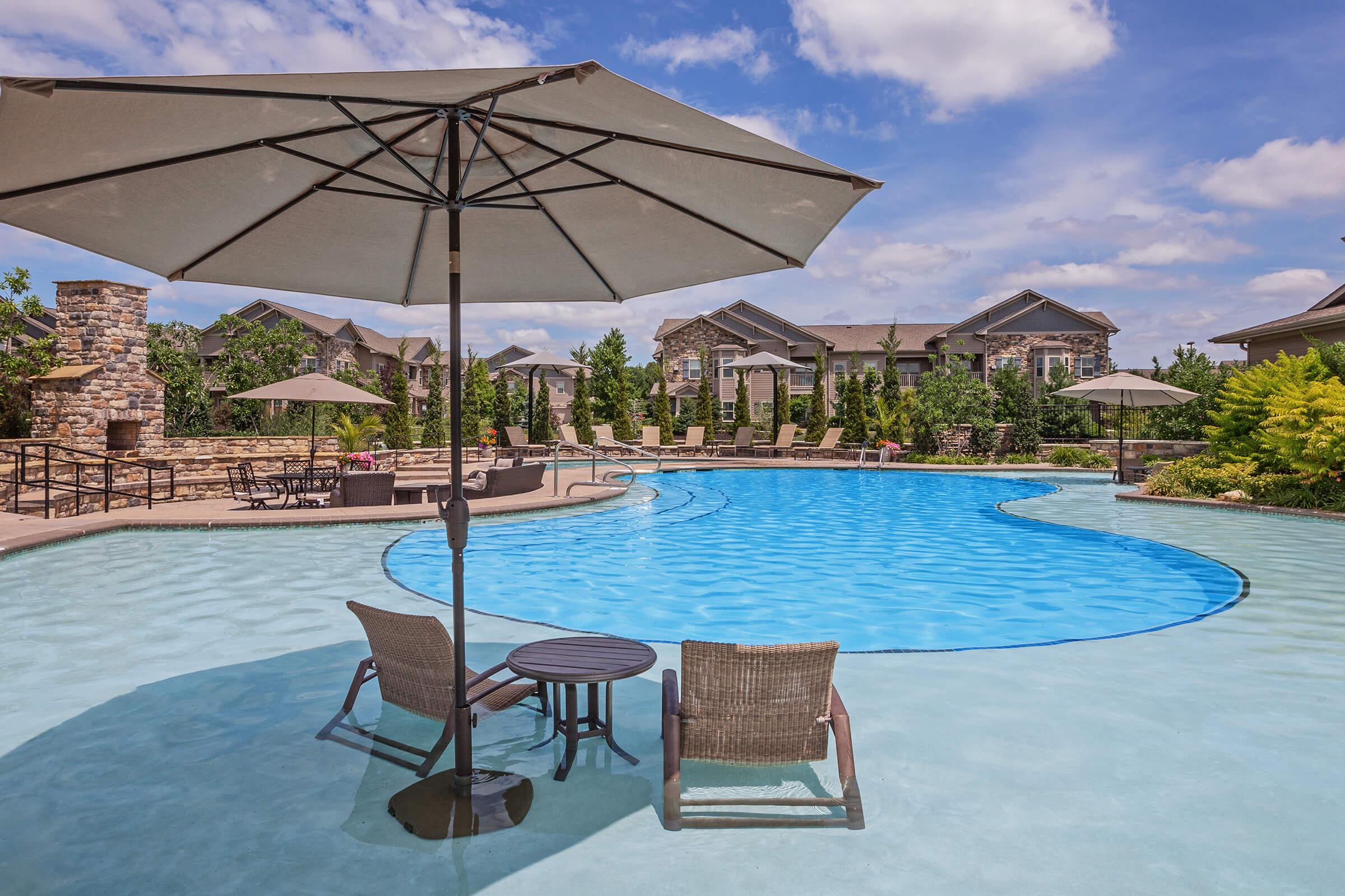 a row of lawn chairs sitting next to a pool of water