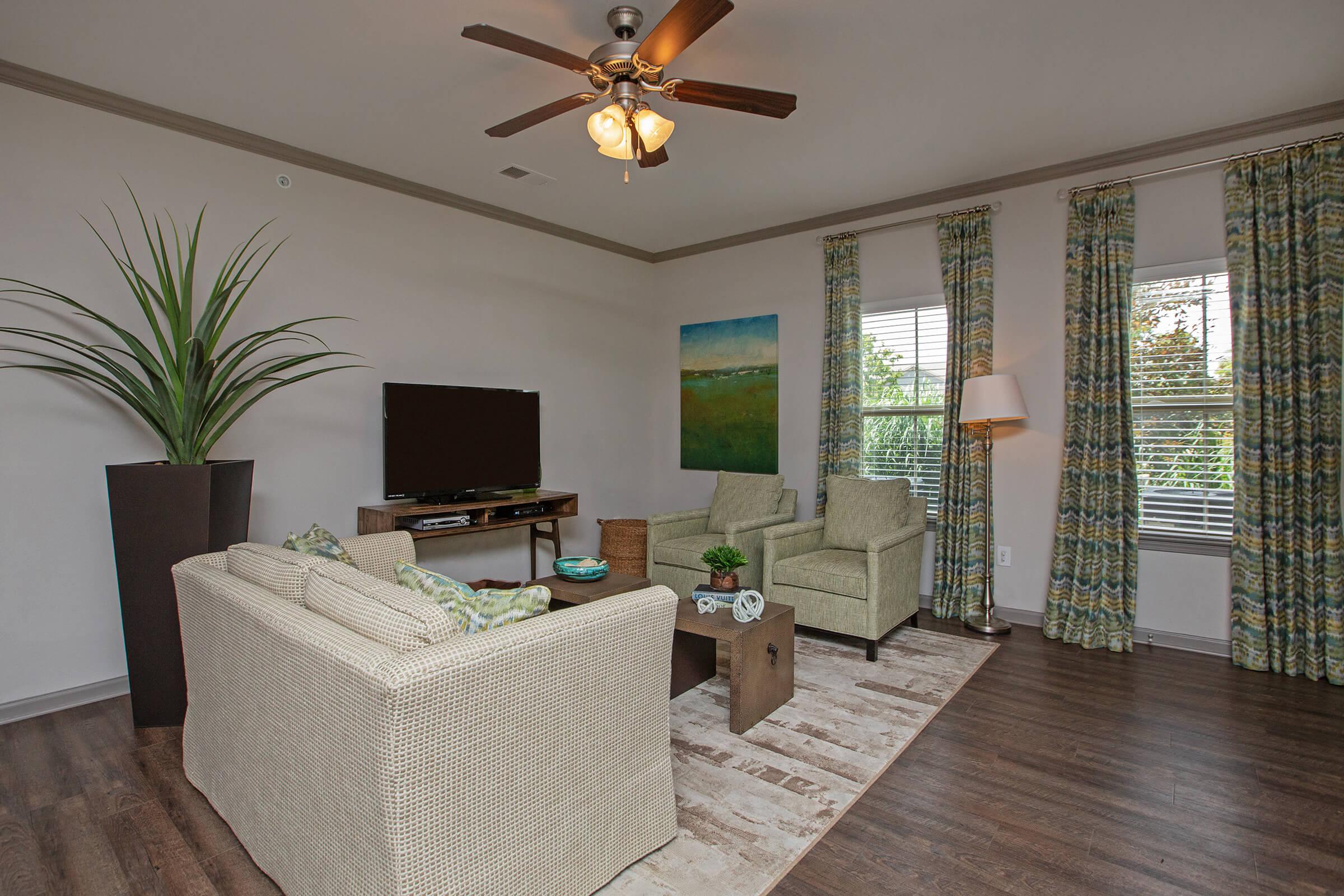 a living room filled with furniture and a large window