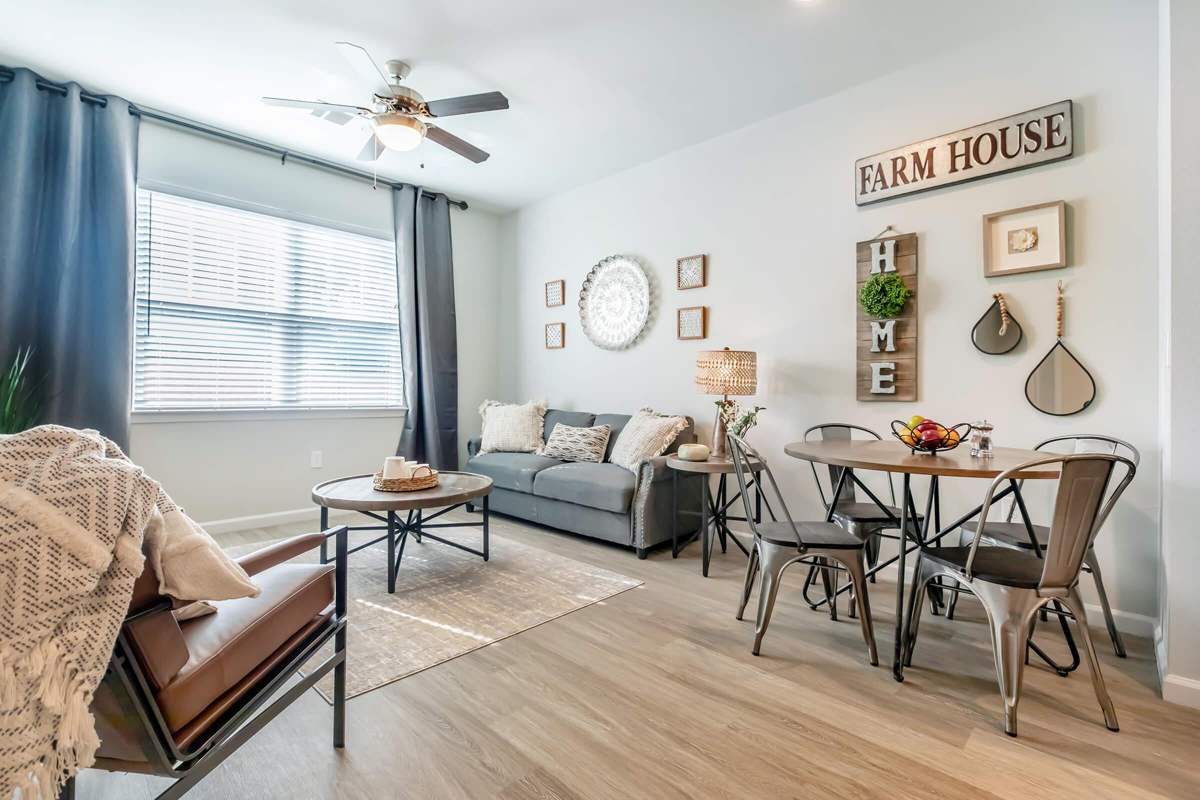 a living room filled with furniture and a large window