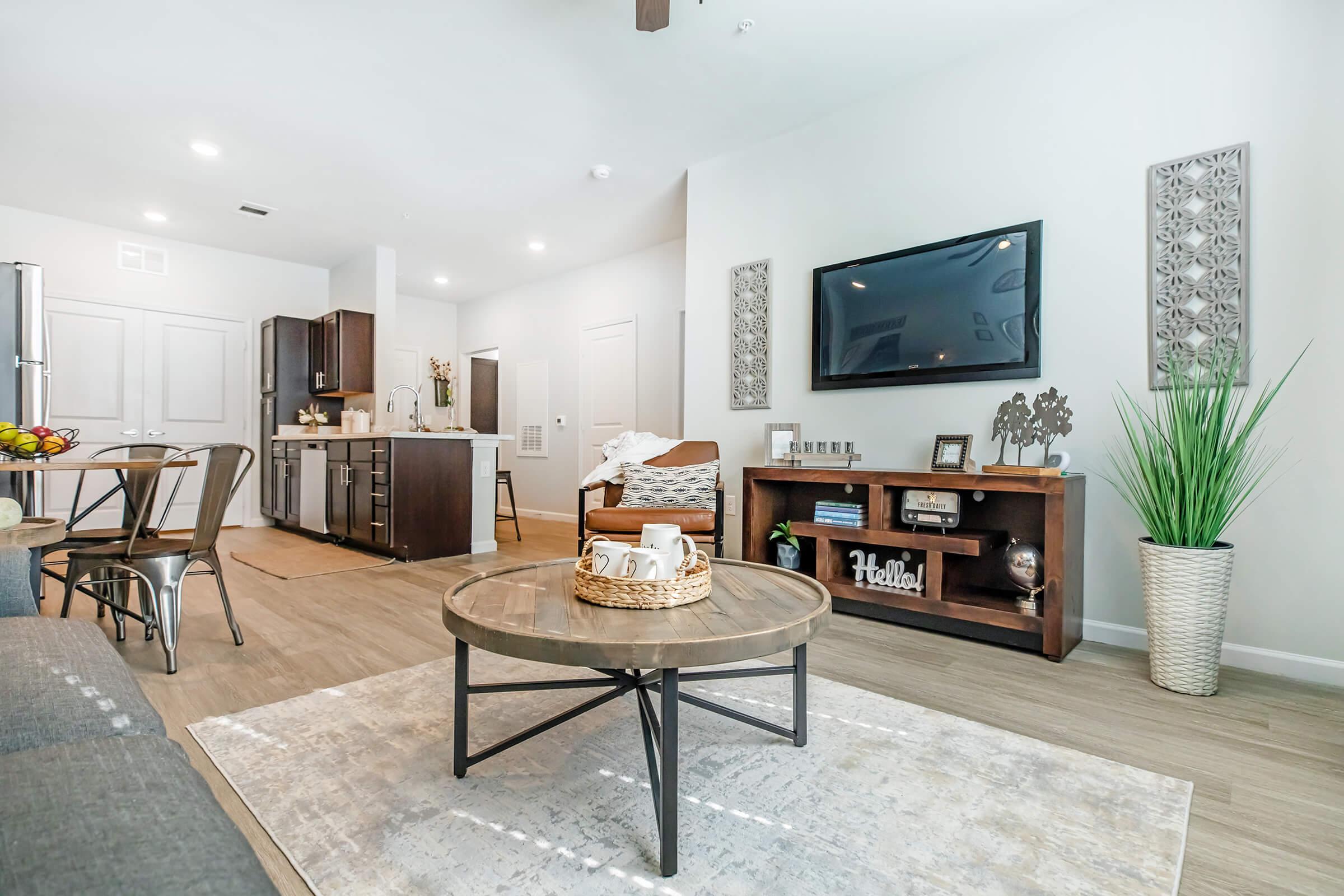 a living room filled with furniture and a flat screen tv