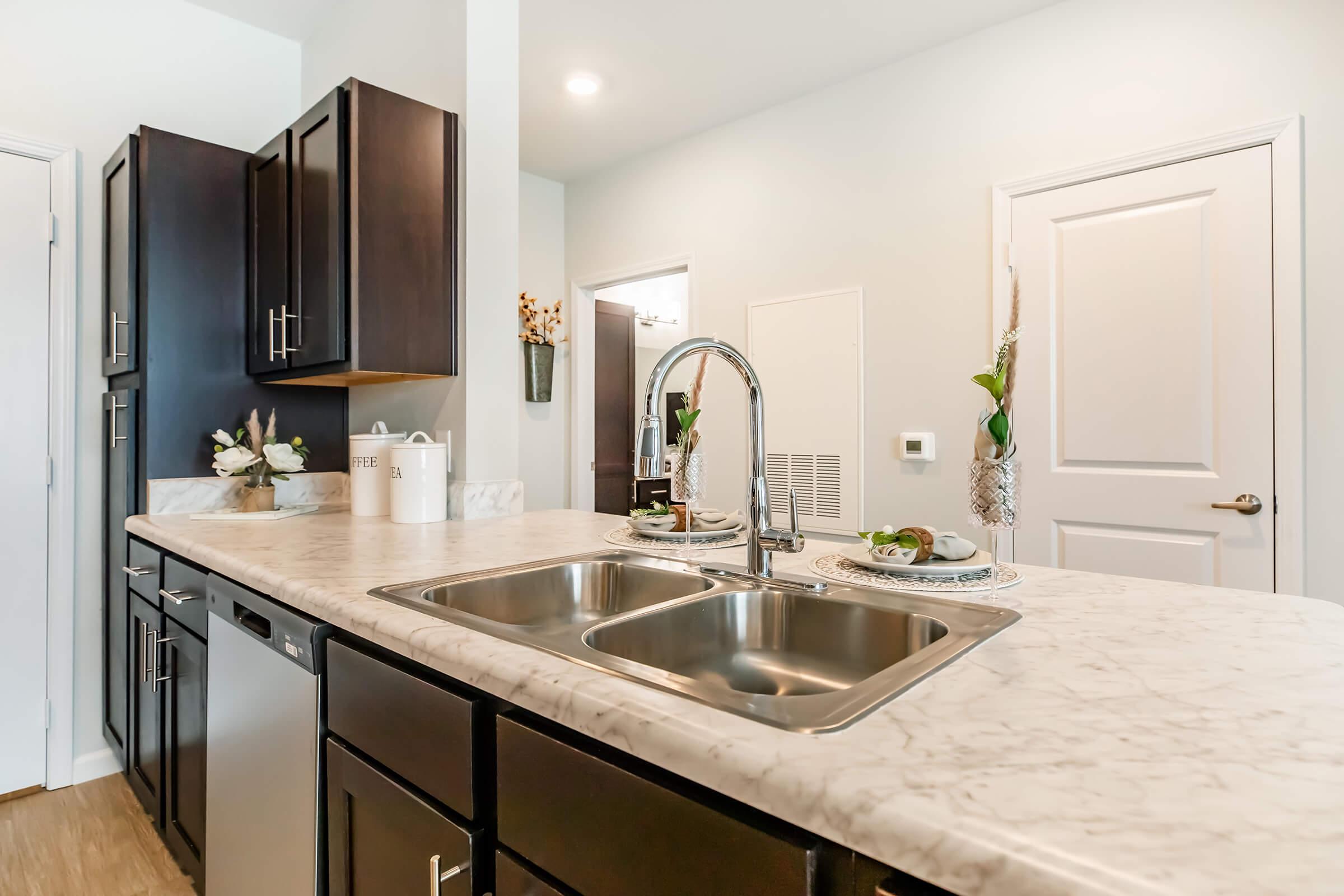 a kitchen with a sink and a mirror