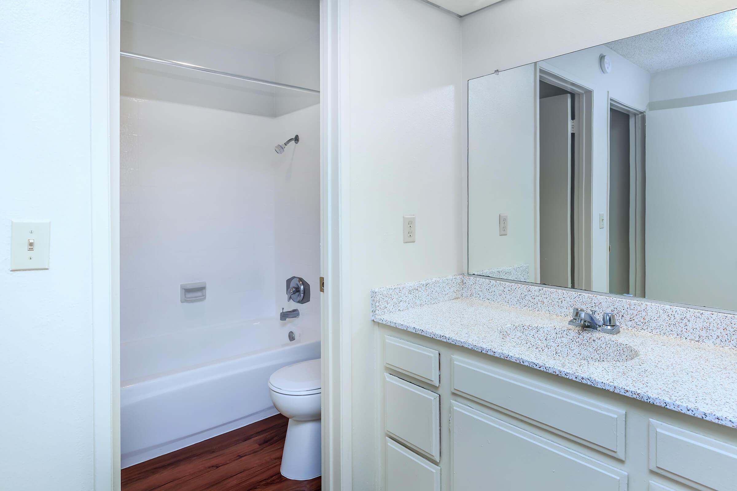 Bathroom sink and mirror with open bathroom door