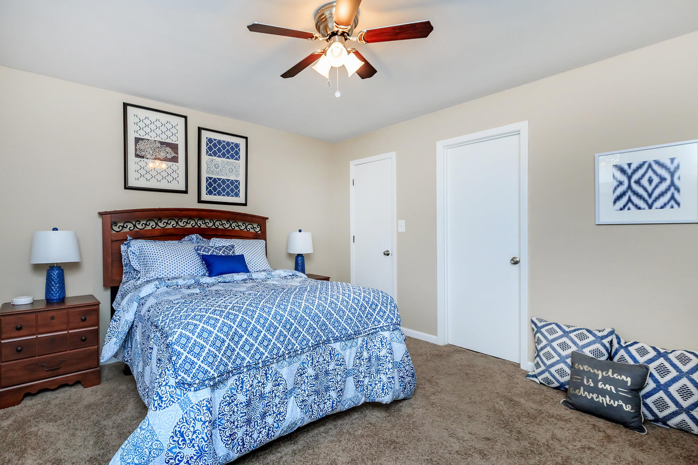 a blue and white bed in a room