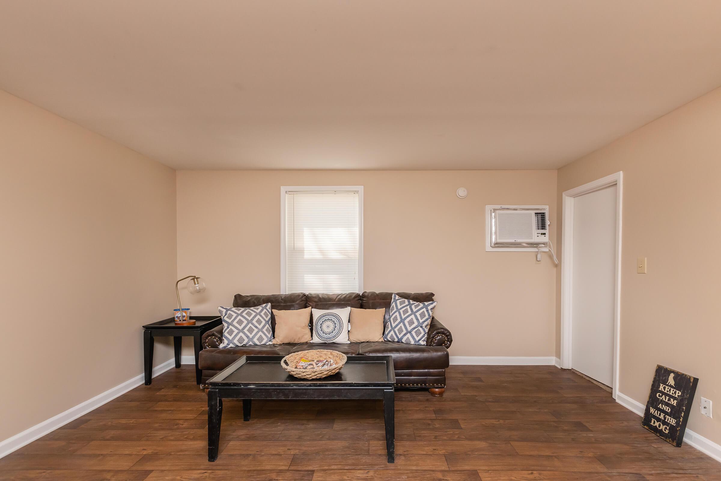 a living room filled with furniture on top of a wooden floor