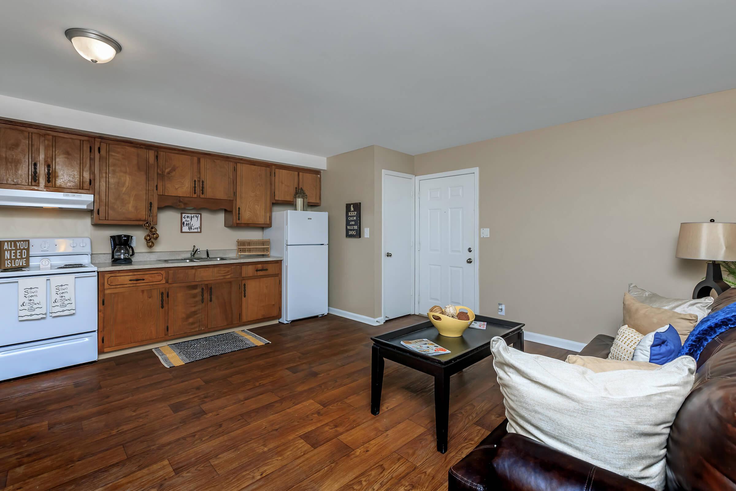 a living room filled with furniture and wood cabinets