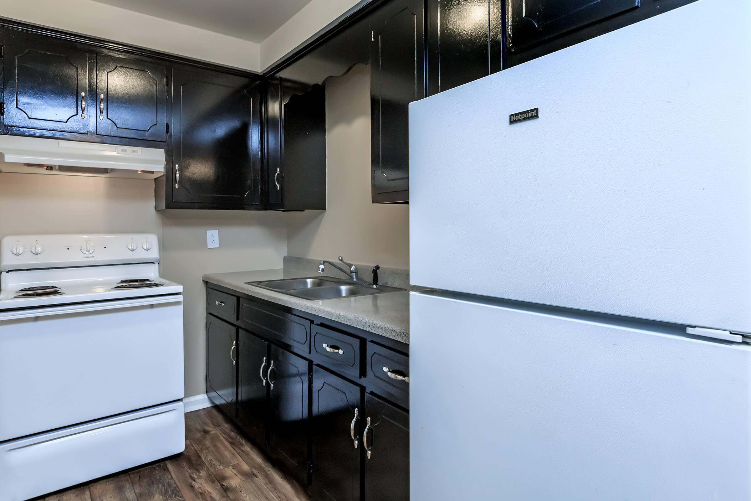 a stove top oven sitting inside of a kitchen