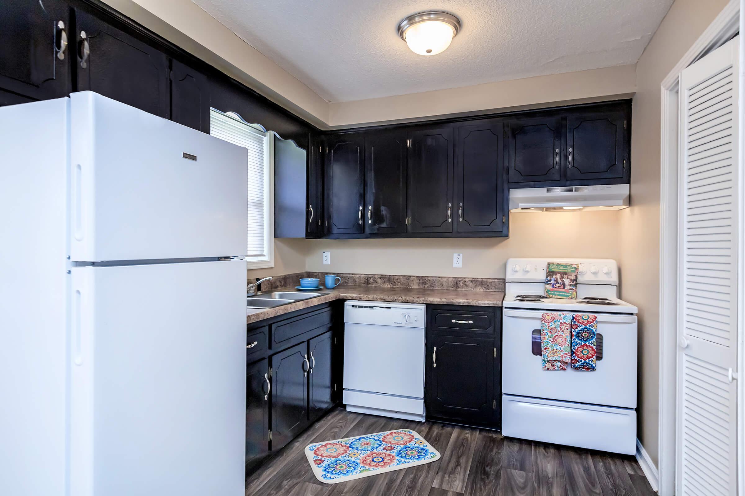 a kitchen with a stove and a refrigerator