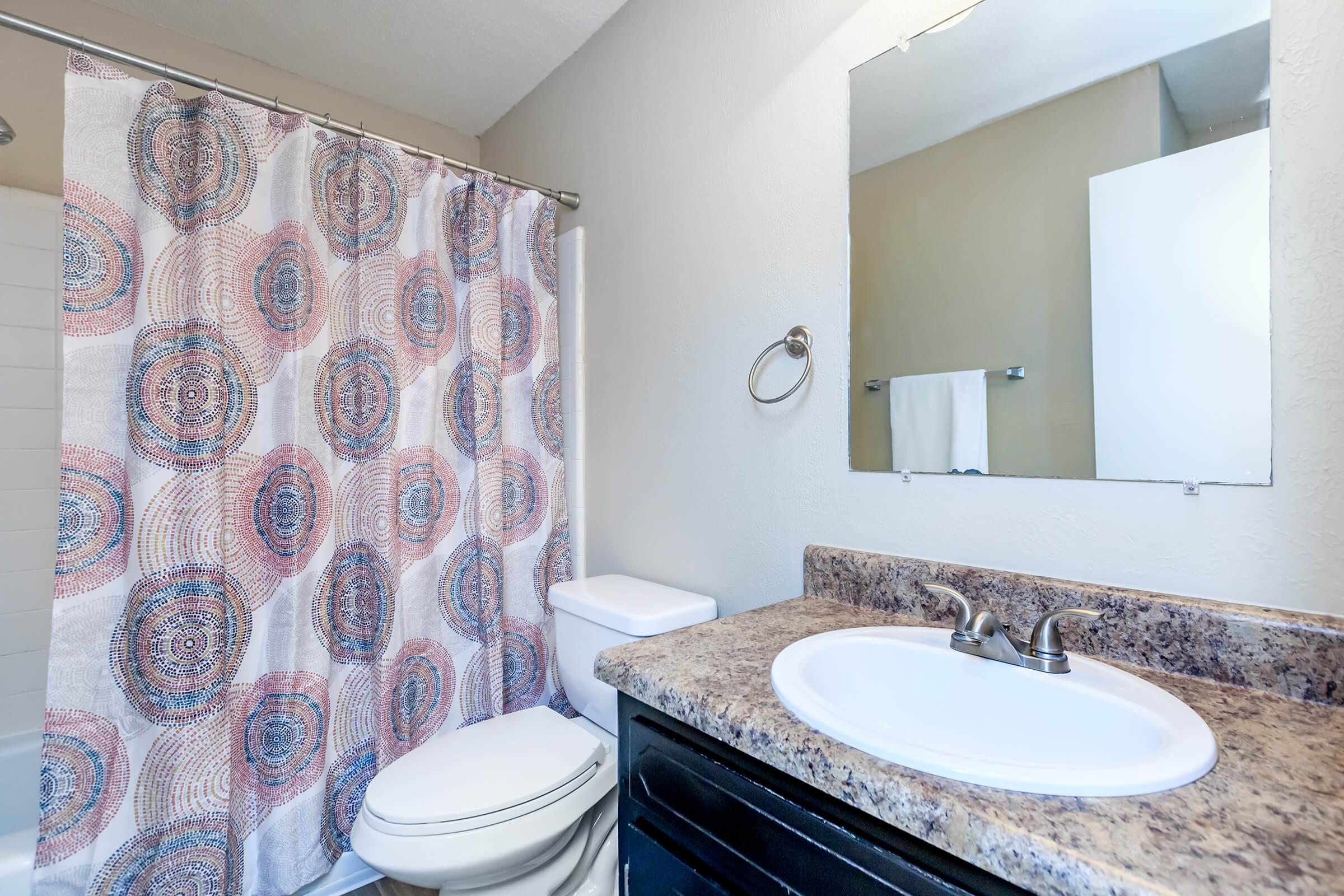 a shower that has a sink and a mirror