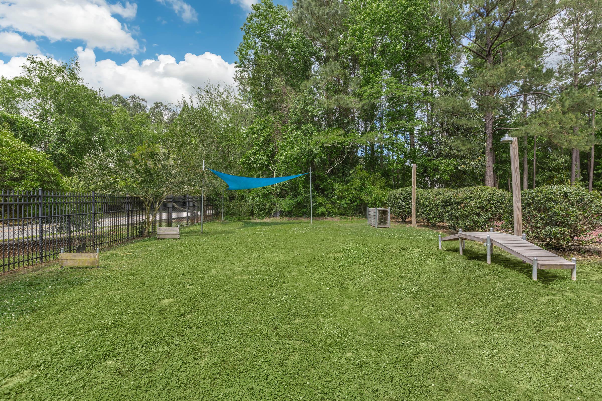 a couple of lawn chairs sitting on top of a lush green field