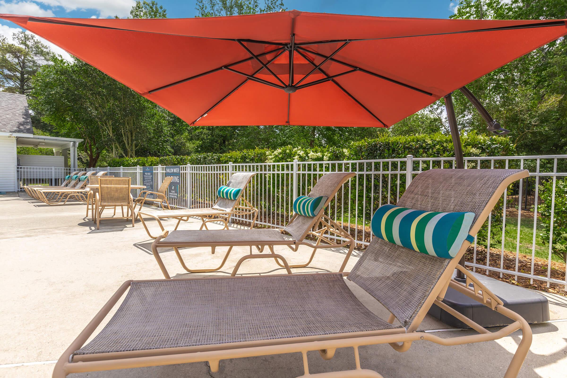 a green lawn chair with an umbrella