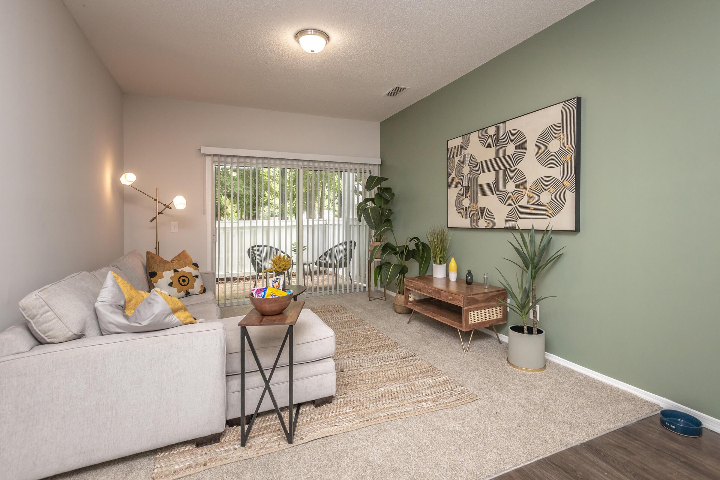 a living room filled with furniture and a large window