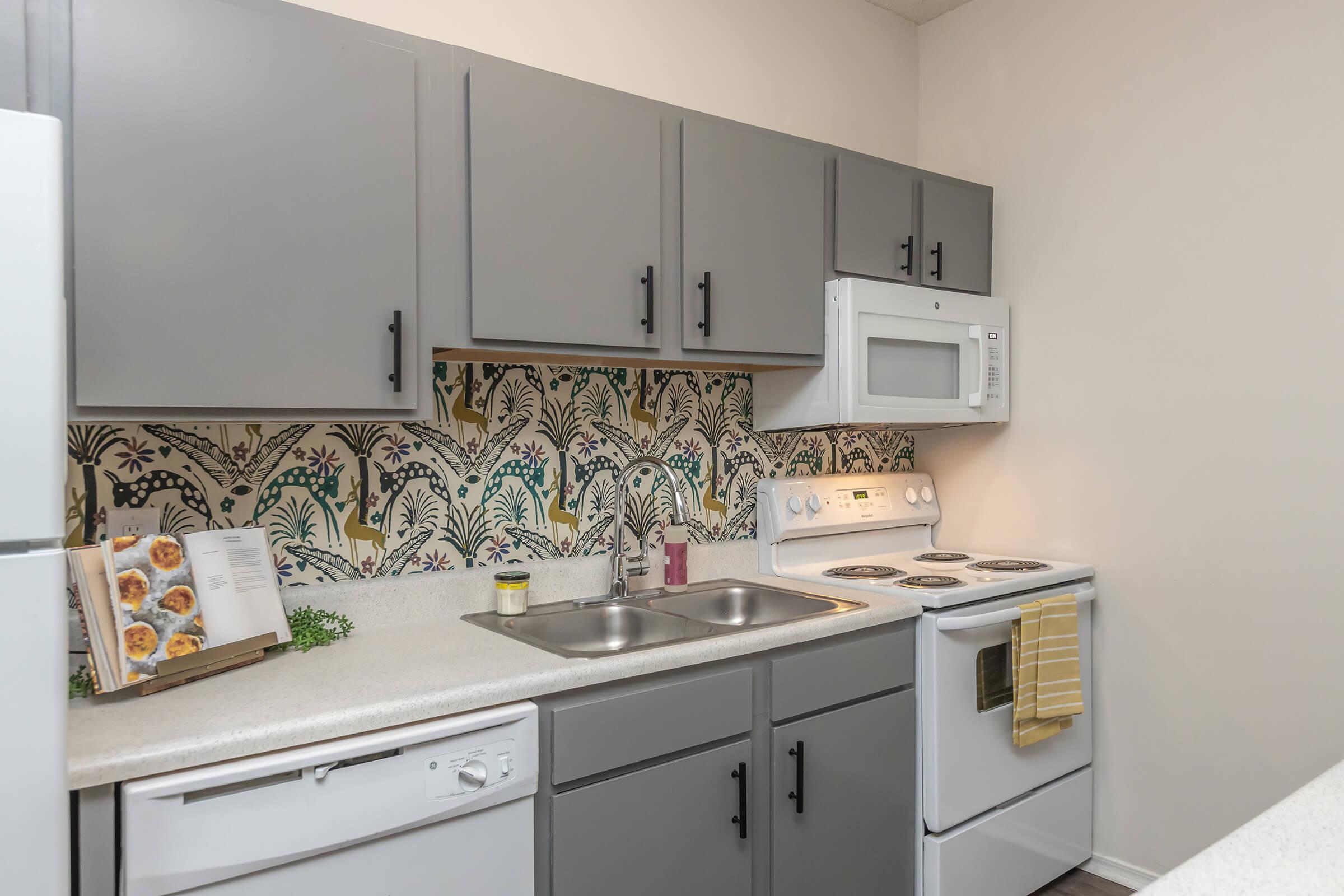 a kitchen with a stove sink and refrigerator