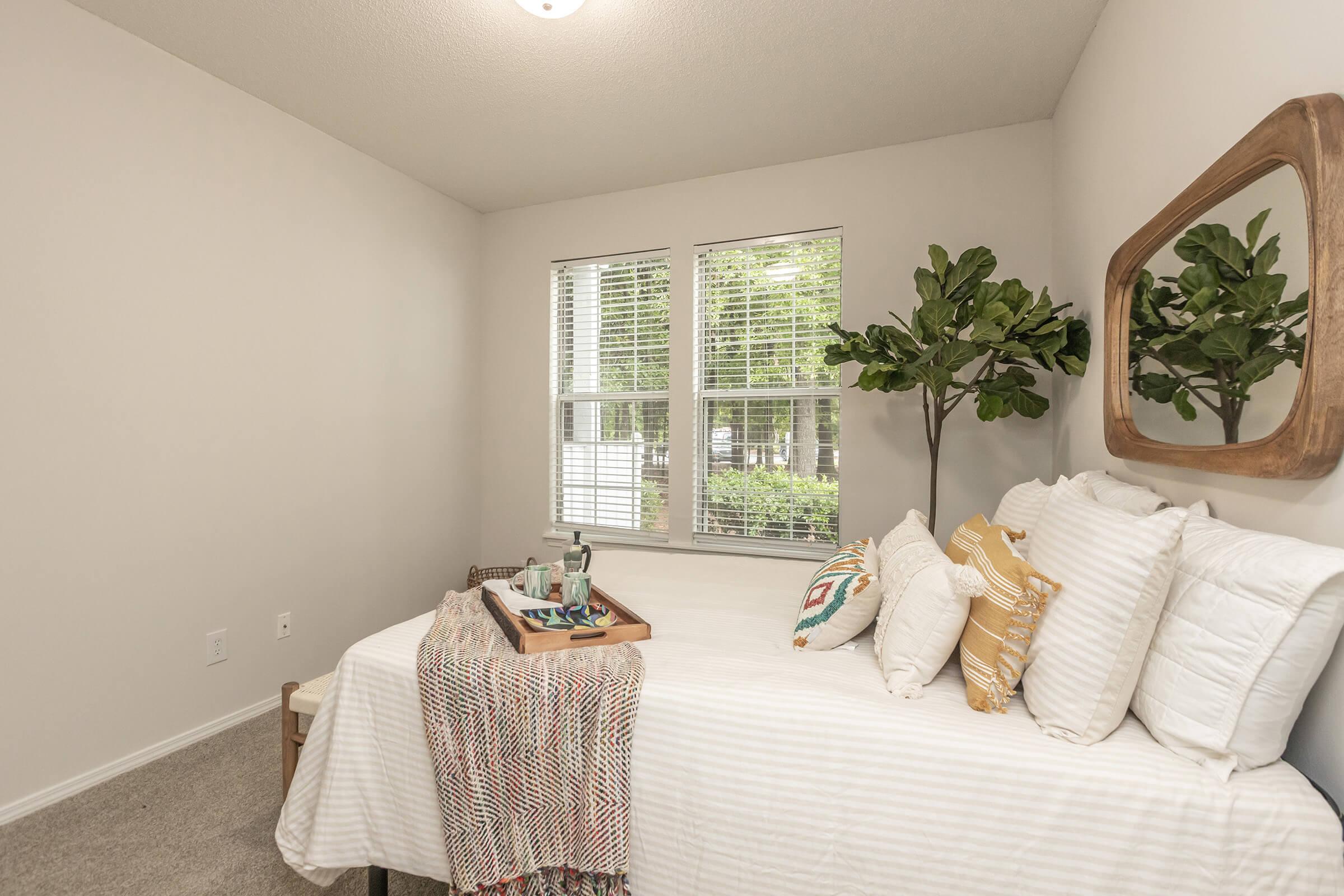 a living room filled with furniture and a large window