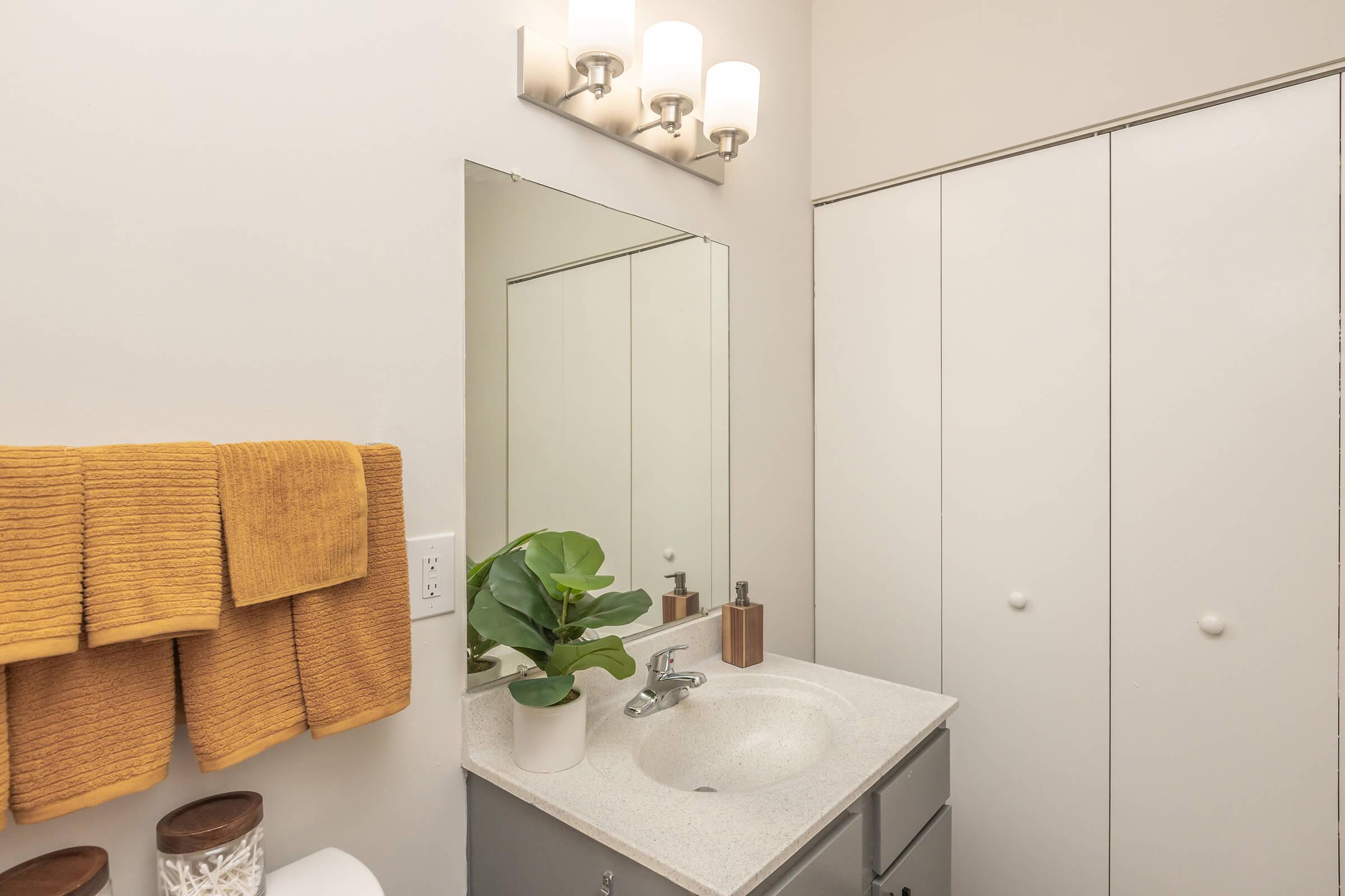 a kitchen with a sink and a mirror