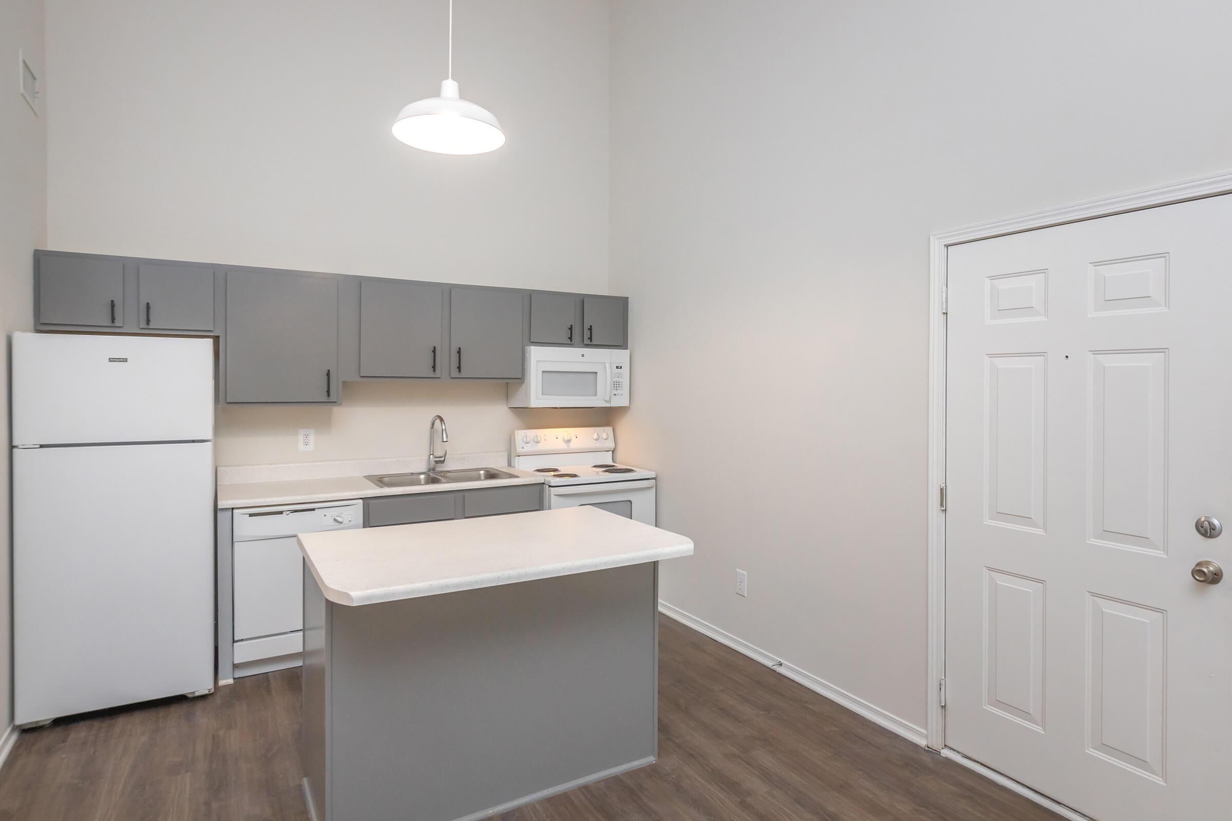 a kitchen with a sink and a refrigerator