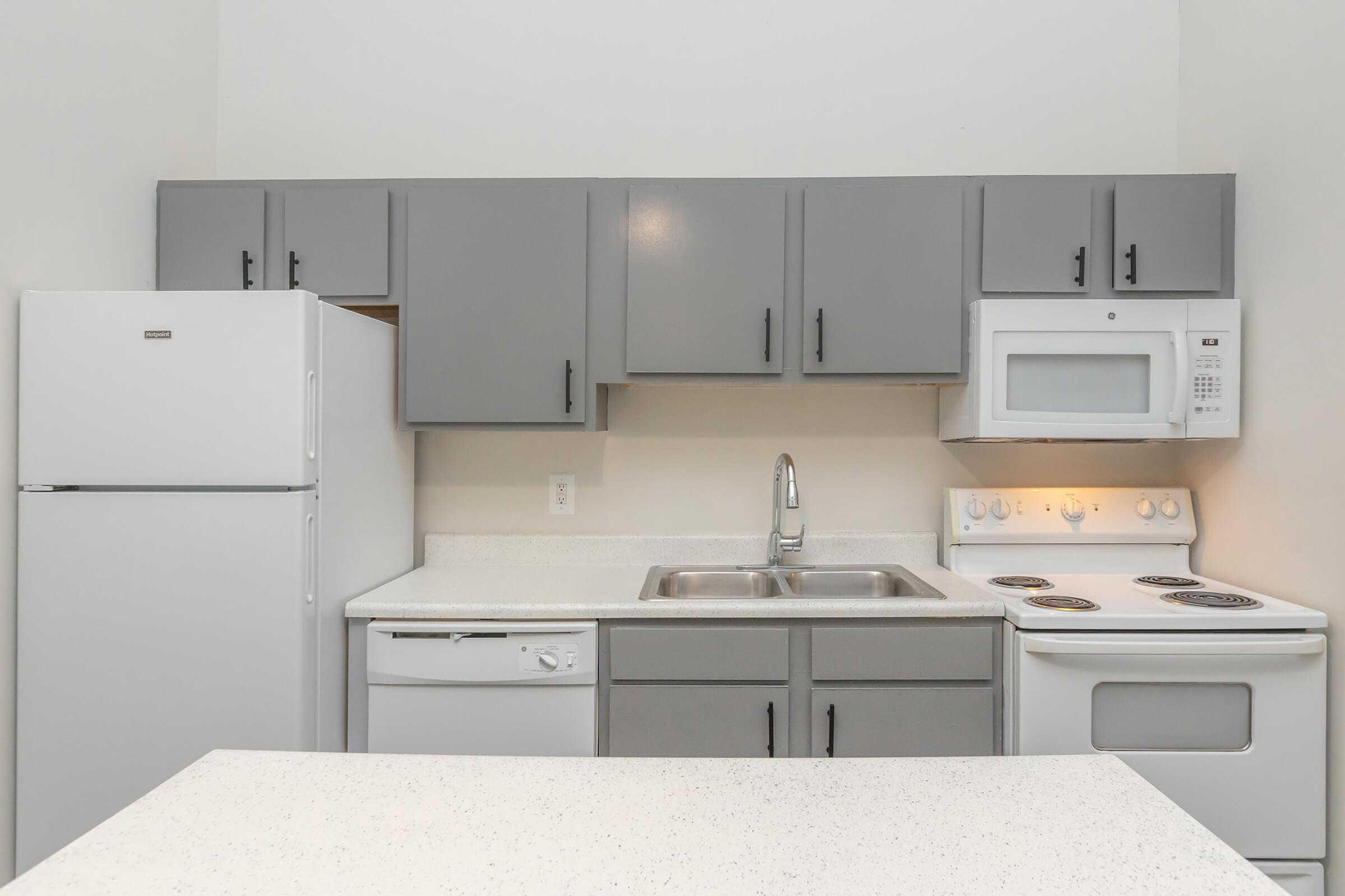 a kitchen with a sink and a refrigerator