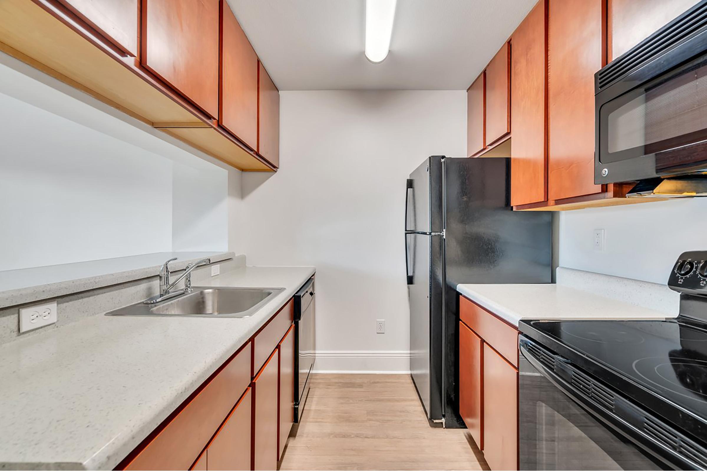 a kitchen with stainless steel appliances and wooden cabinets