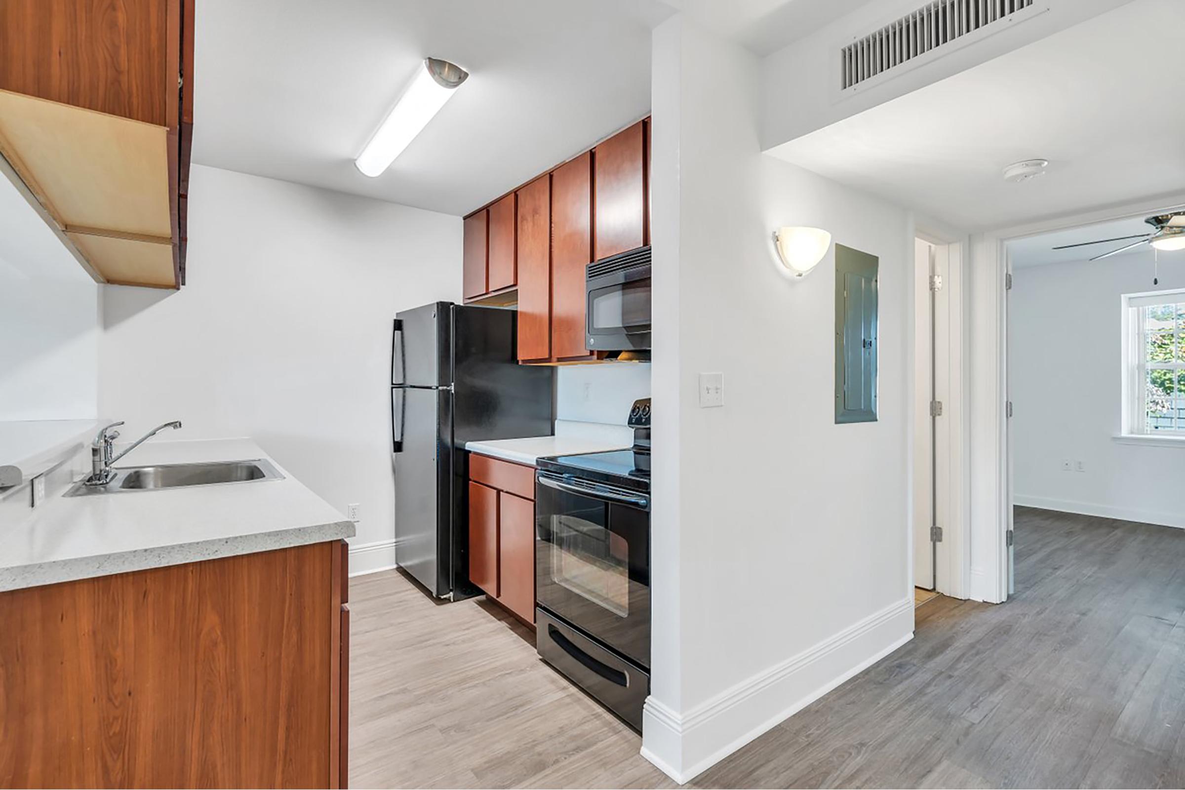 a kitchen with a sink and a refrigerator