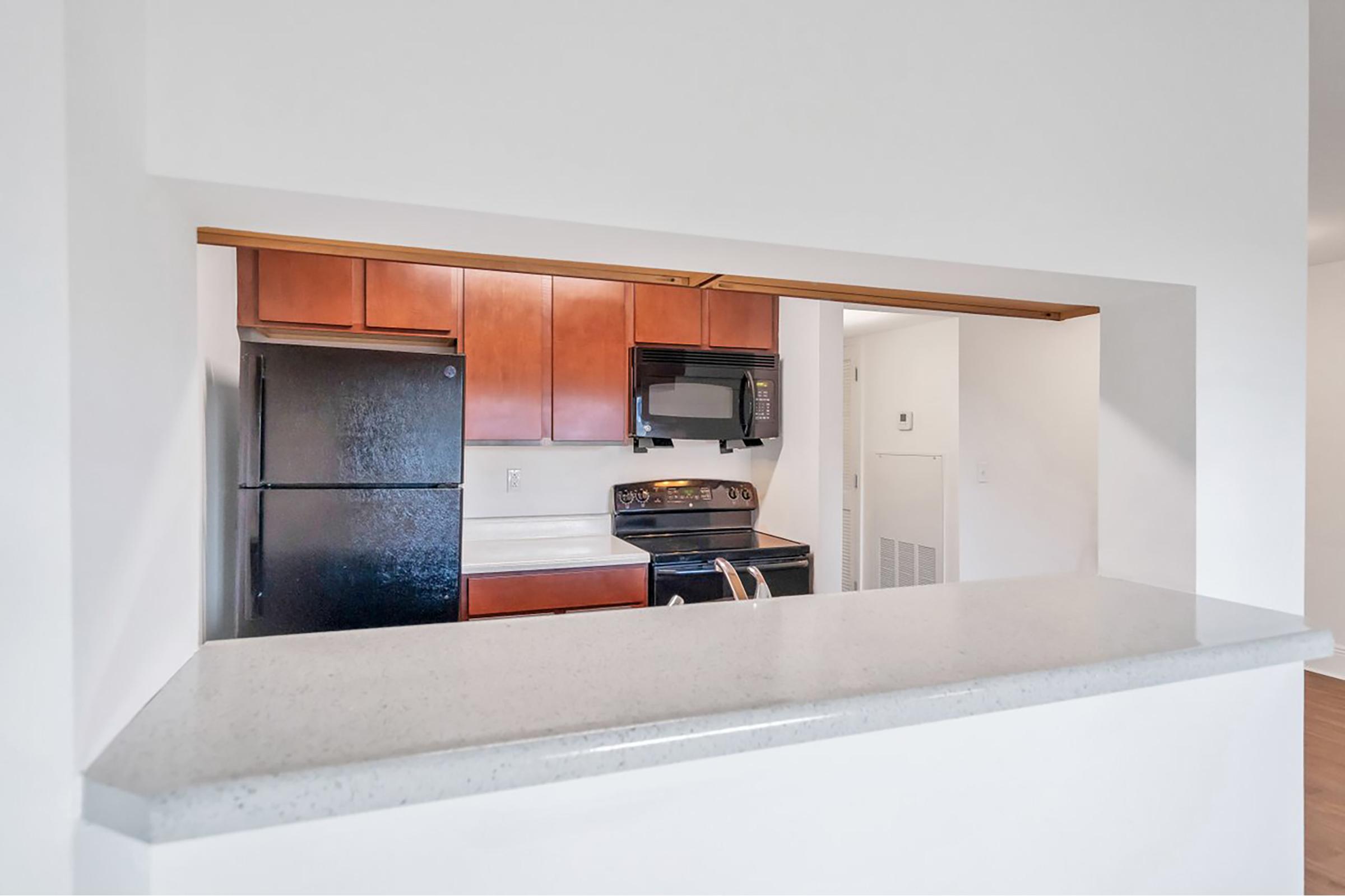 a kitchen with a refrigerator and a microwave