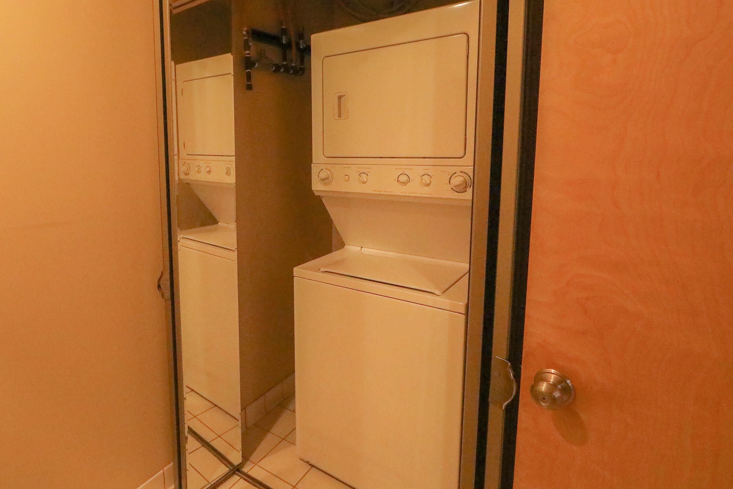 a white refrigerator freezer sitting next to a door