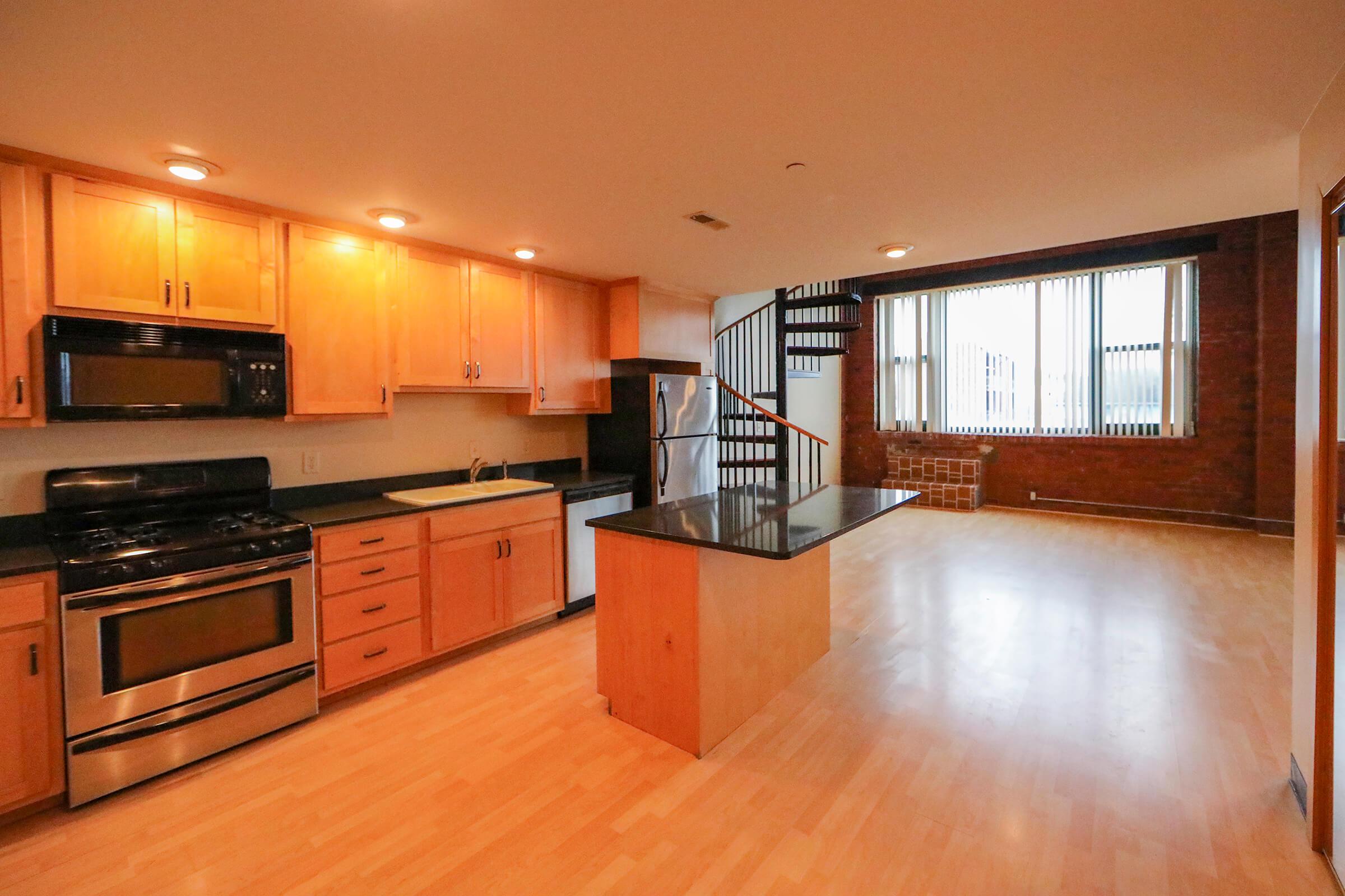 a modern kitchen with stainless steel appliances and wooden cabinets