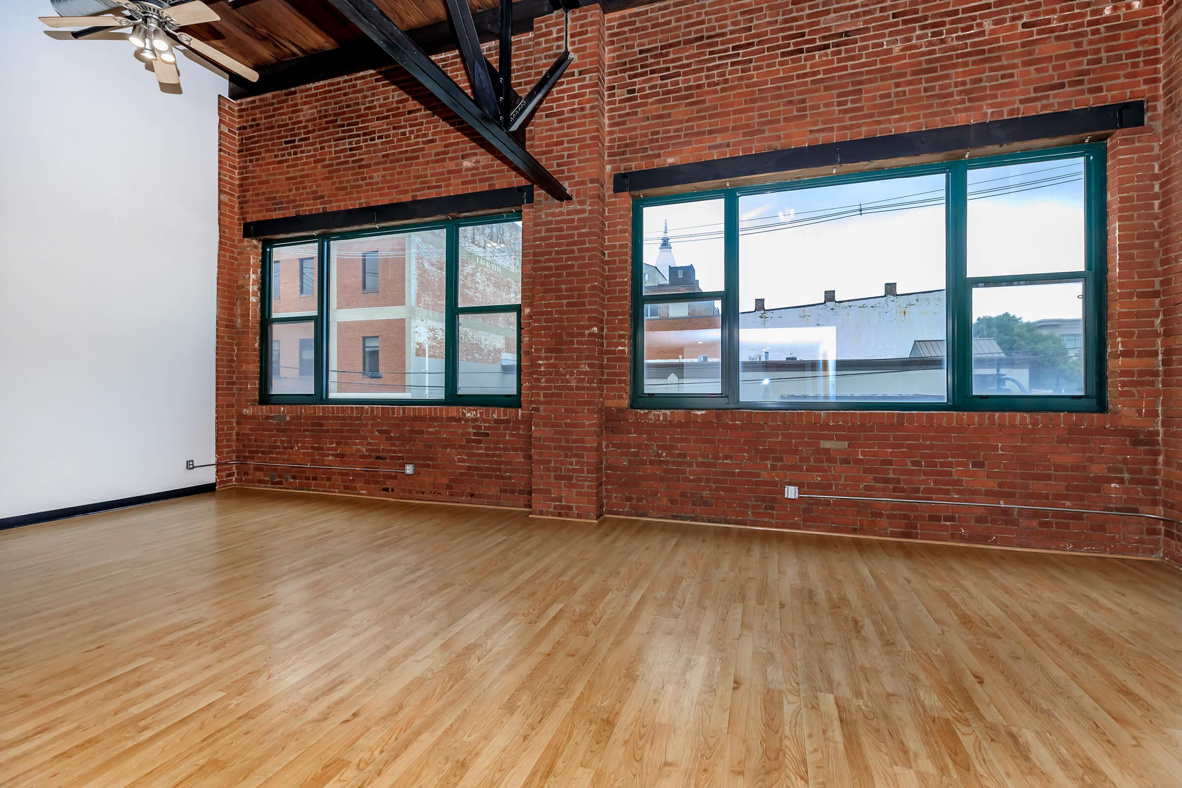 a large brown brick building next to a window