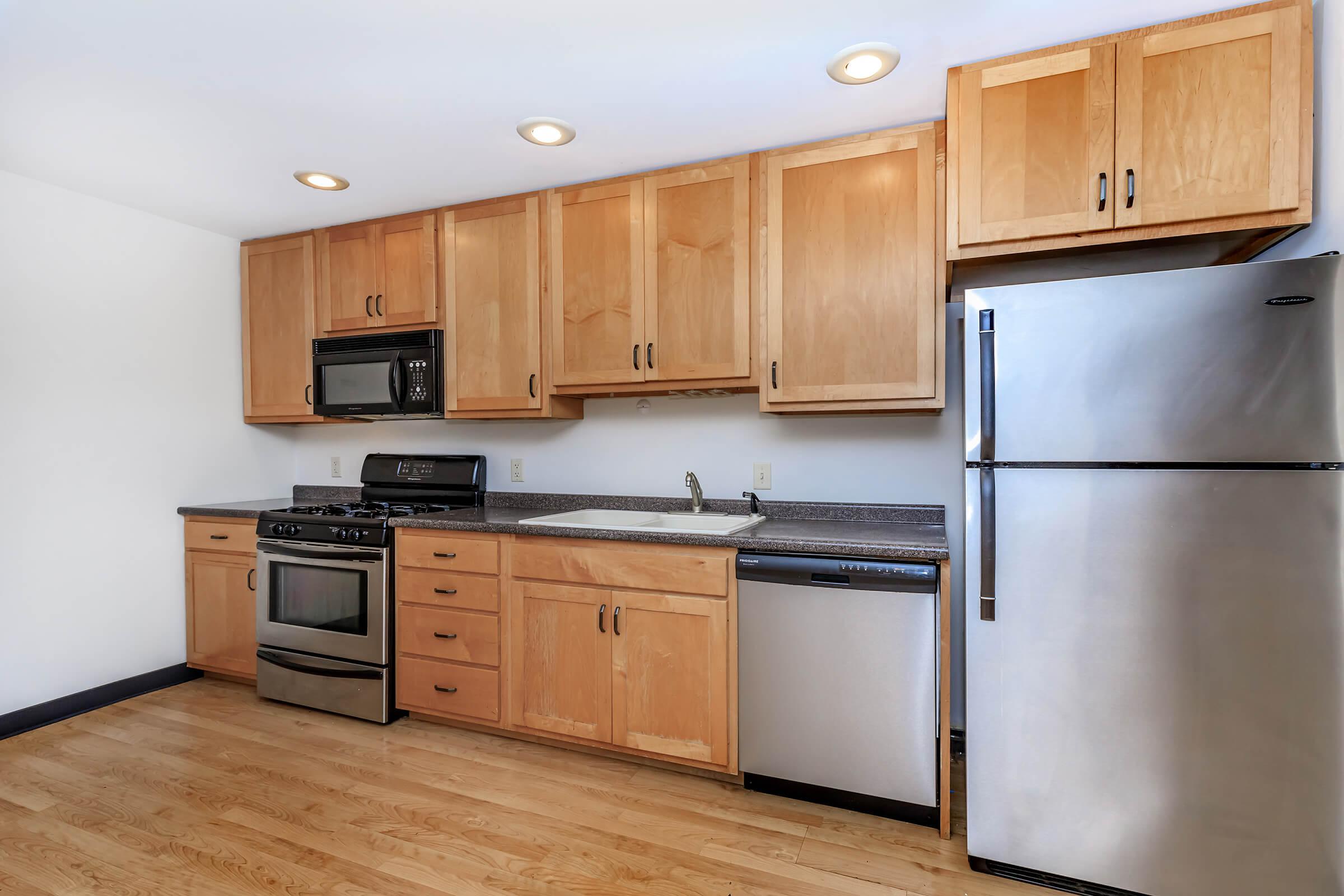 a kitchen with stainless steel appliances and wooden cabinets