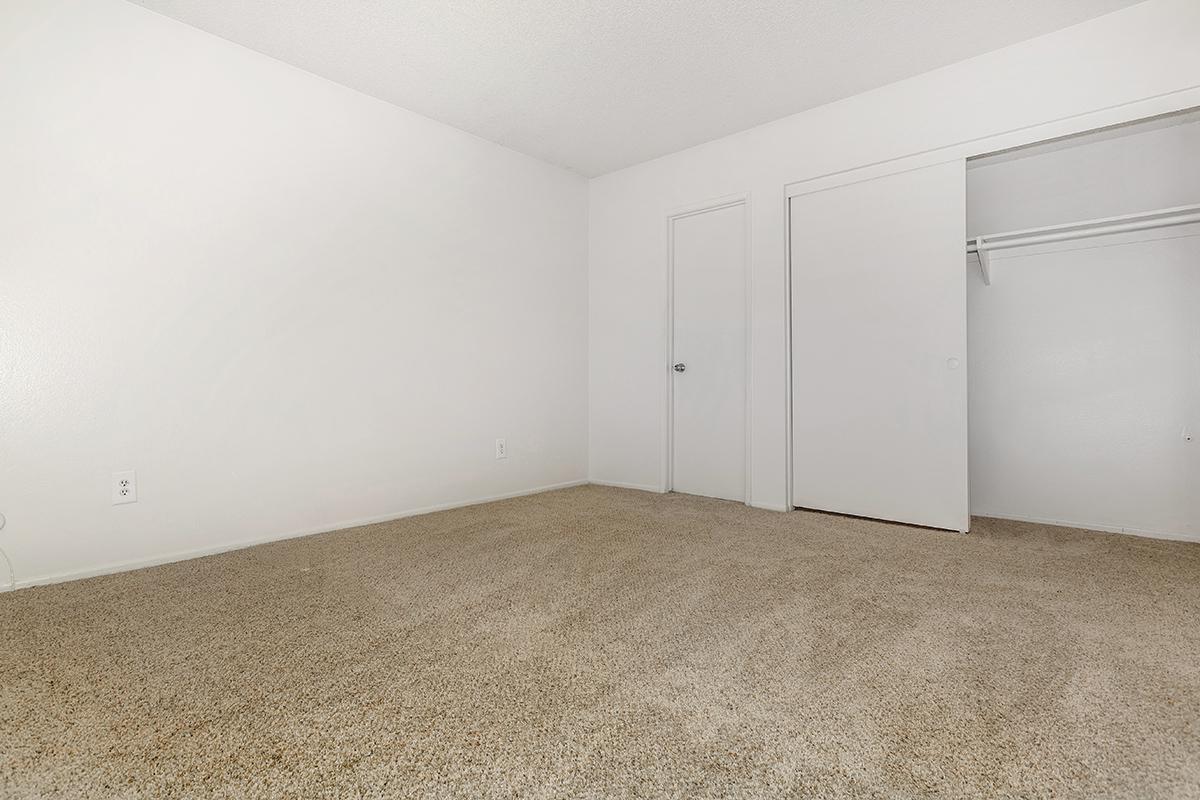 Unfurnished bedroom with open sliding closet door