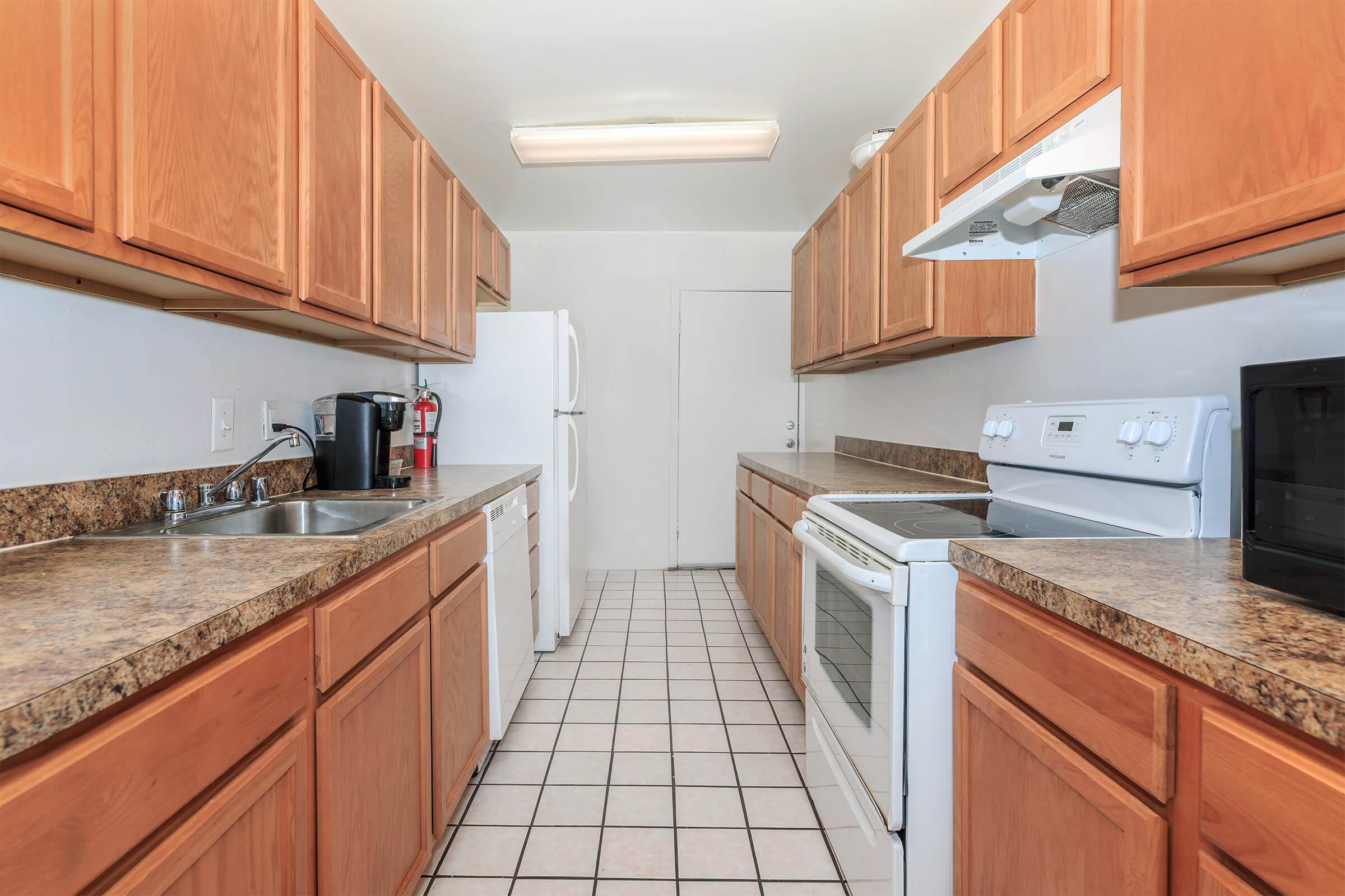 a kitchen with stainless steel appliances and wooden cabinets