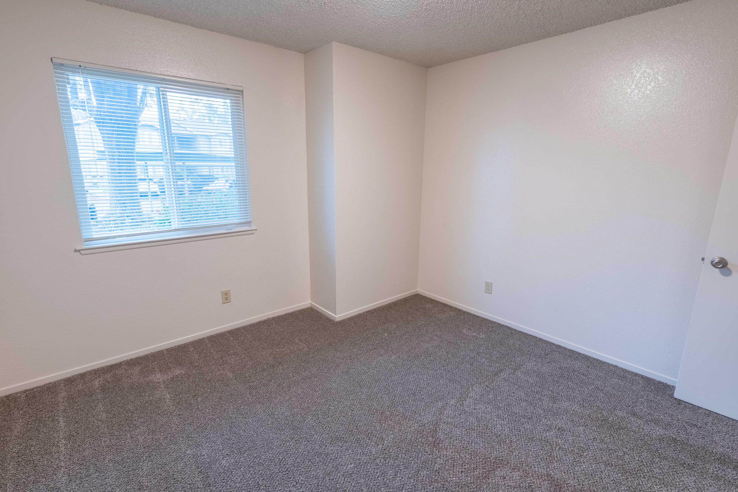 a bedroom with a large window