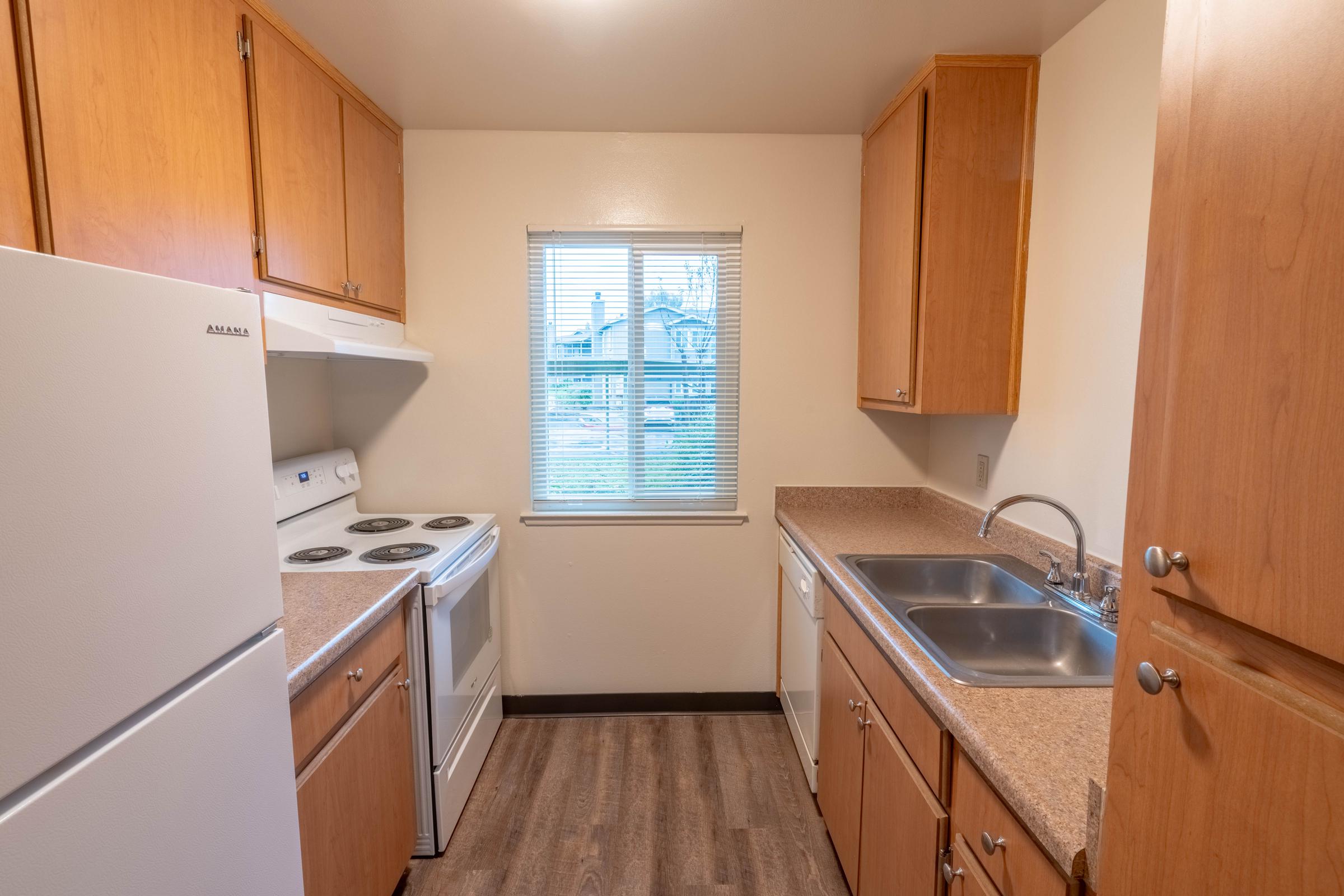 a kitchen with a sink and a refrigerator