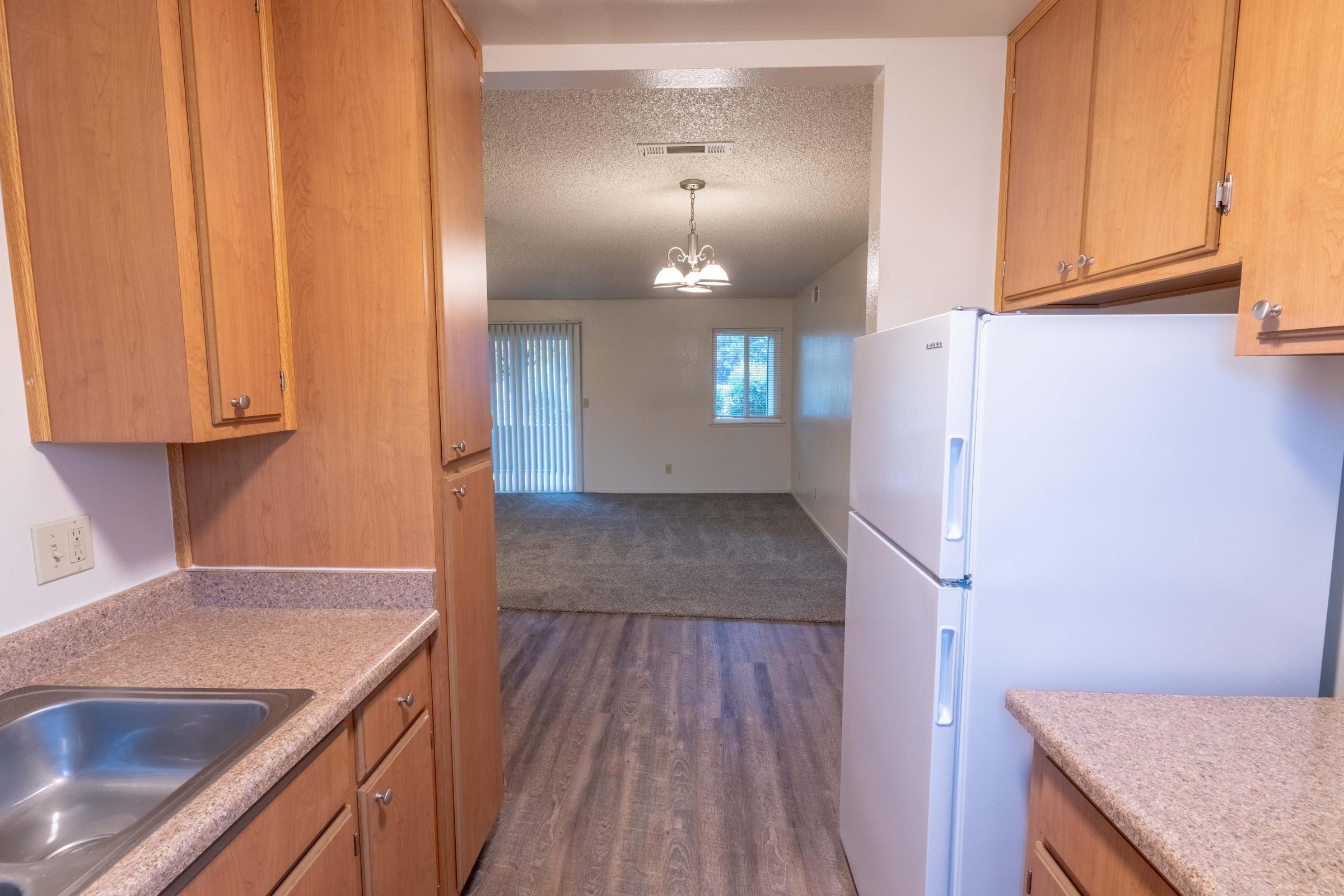 a kitchen with stainless steel appliances and wooden cabinets