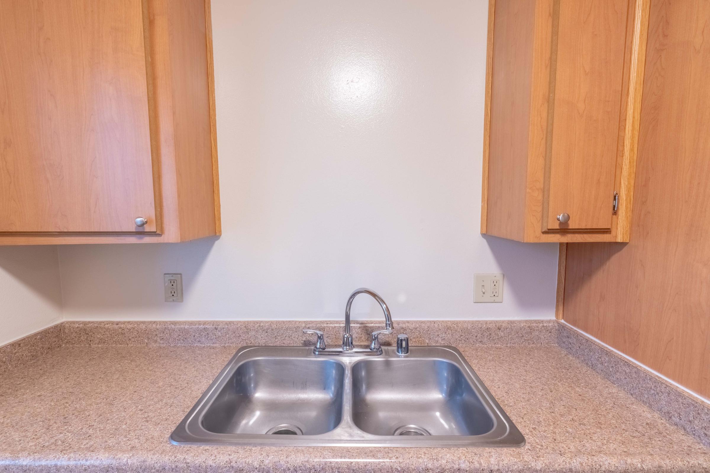 a kitchen with a sink and a microwave