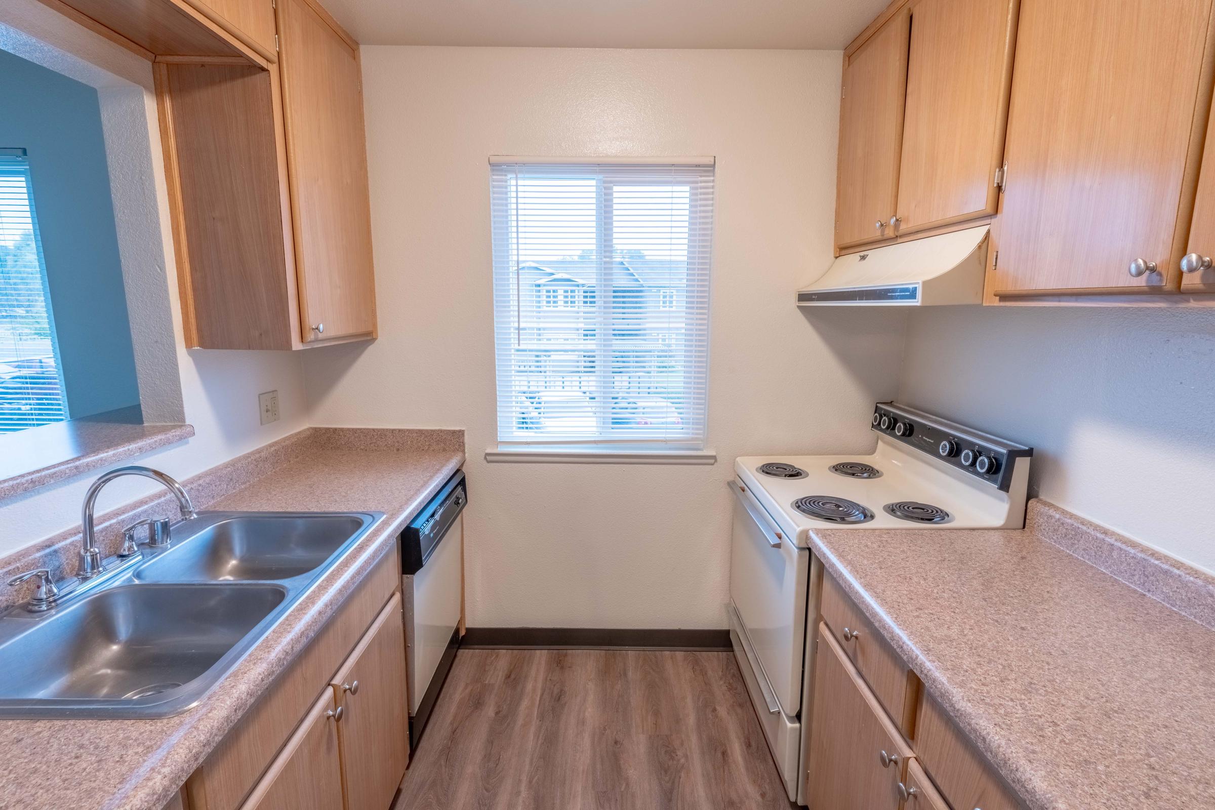 a kitchen with a sink and a window