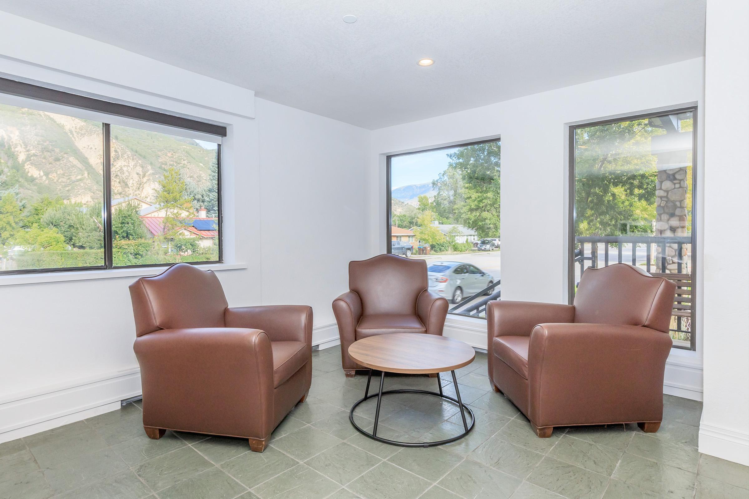 a living room filled with furniture and a large window