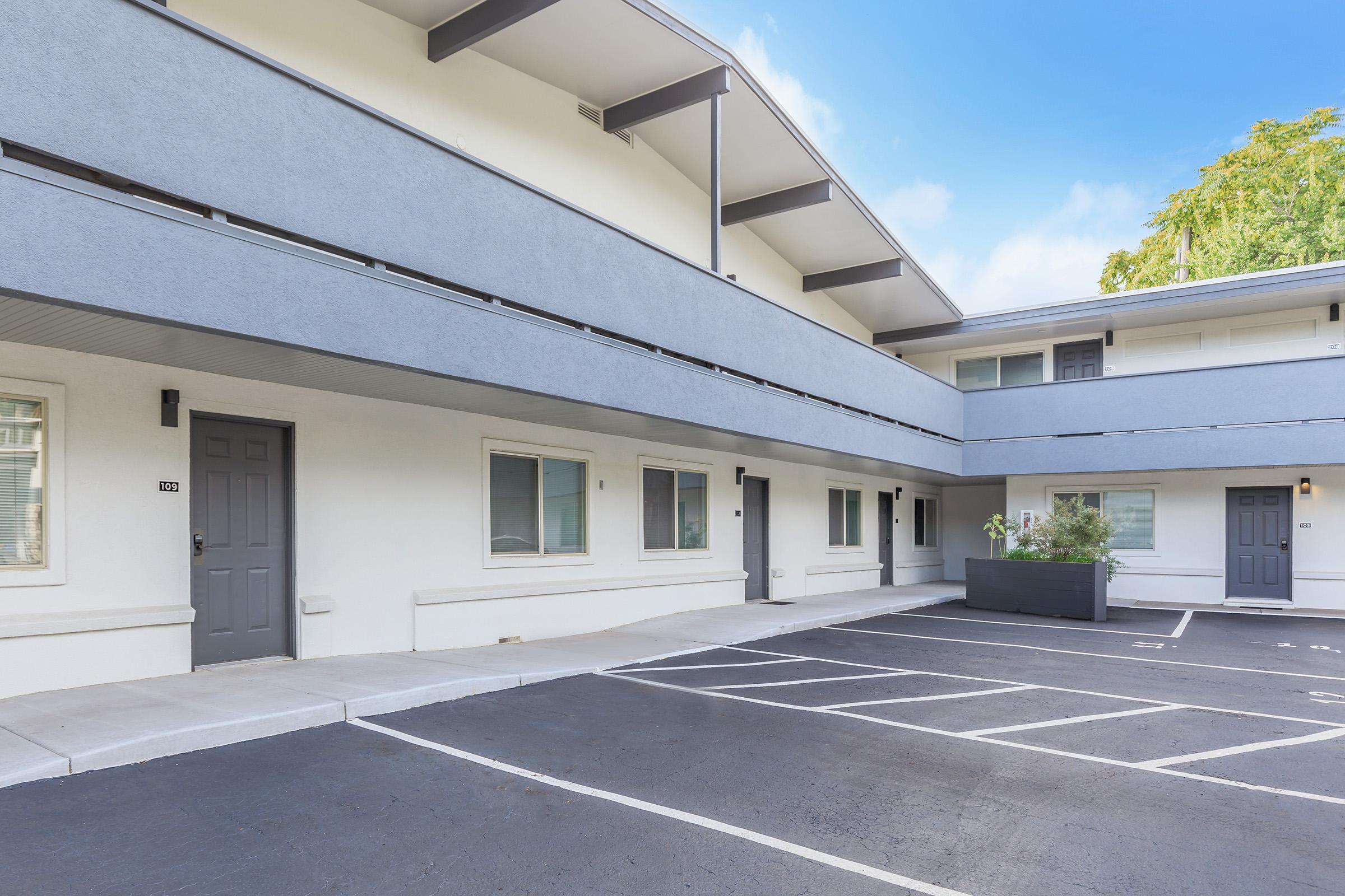 an empty parking lot in front of a building