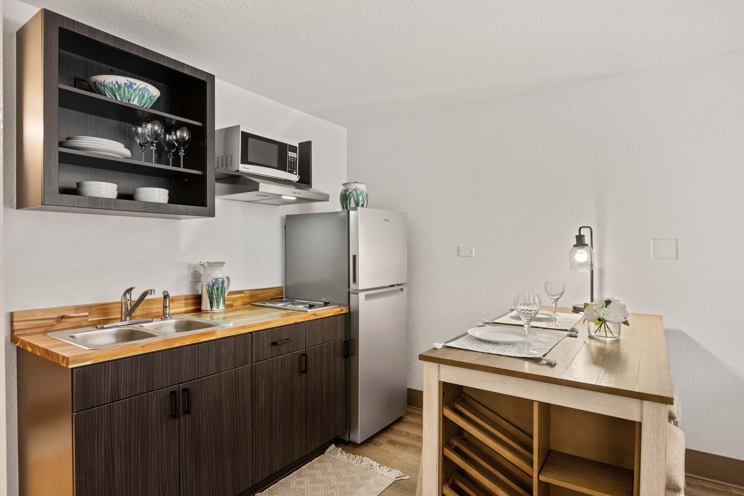 a kitchen with a sink and a mirror