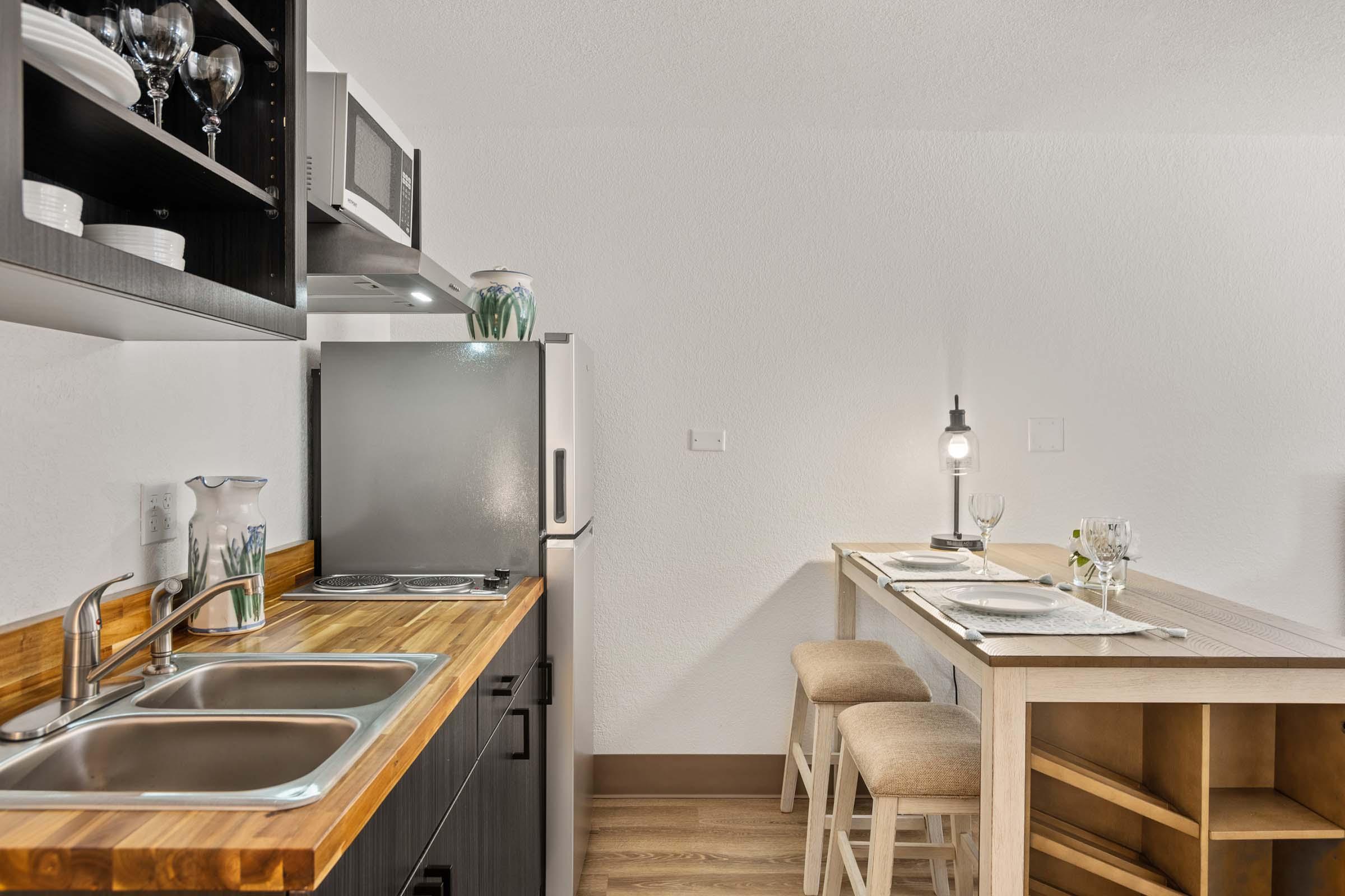 a kitchen with a table and chairs