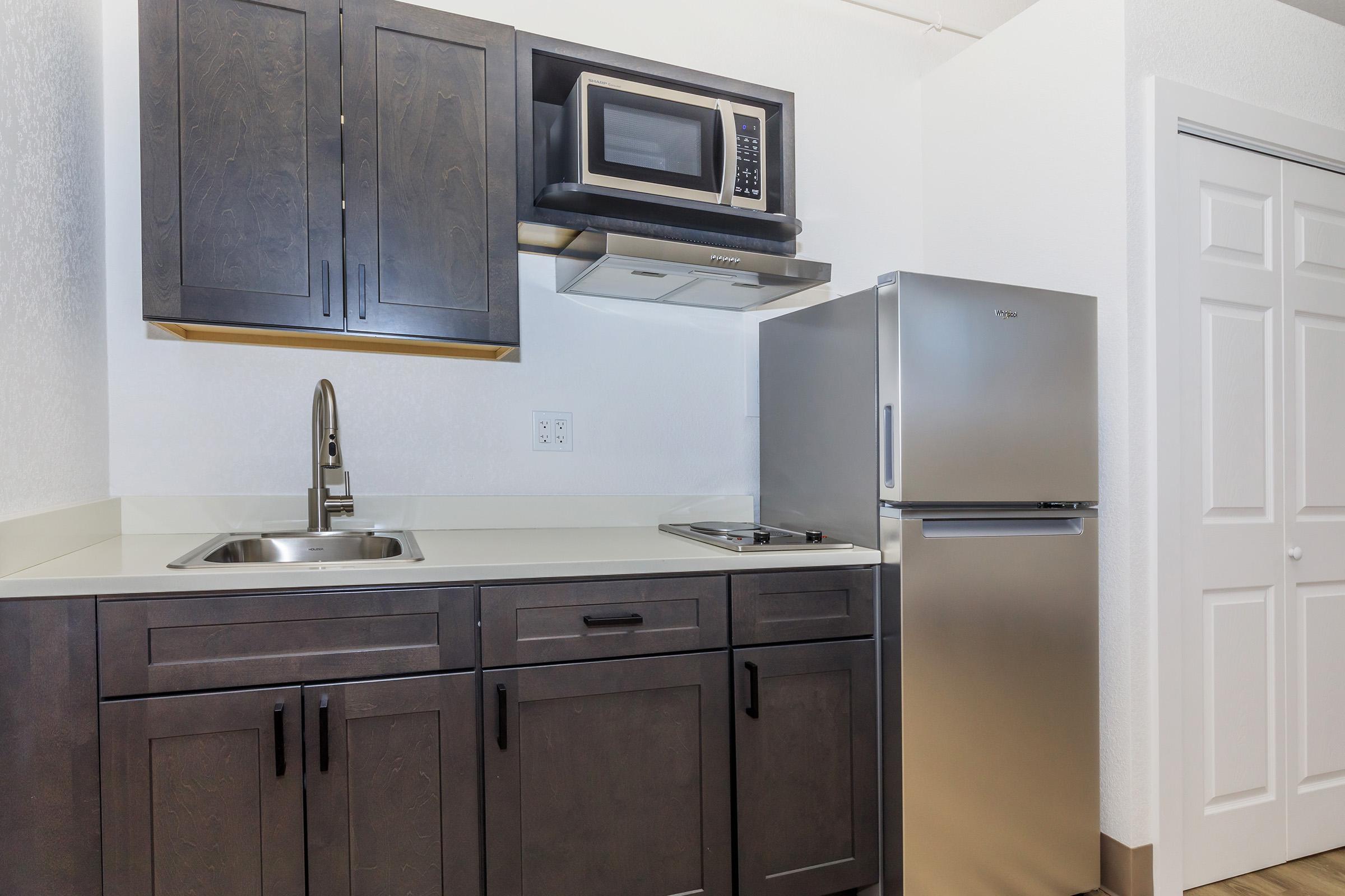 a kitchen with a stove top oven sitting inside of a refrigerator