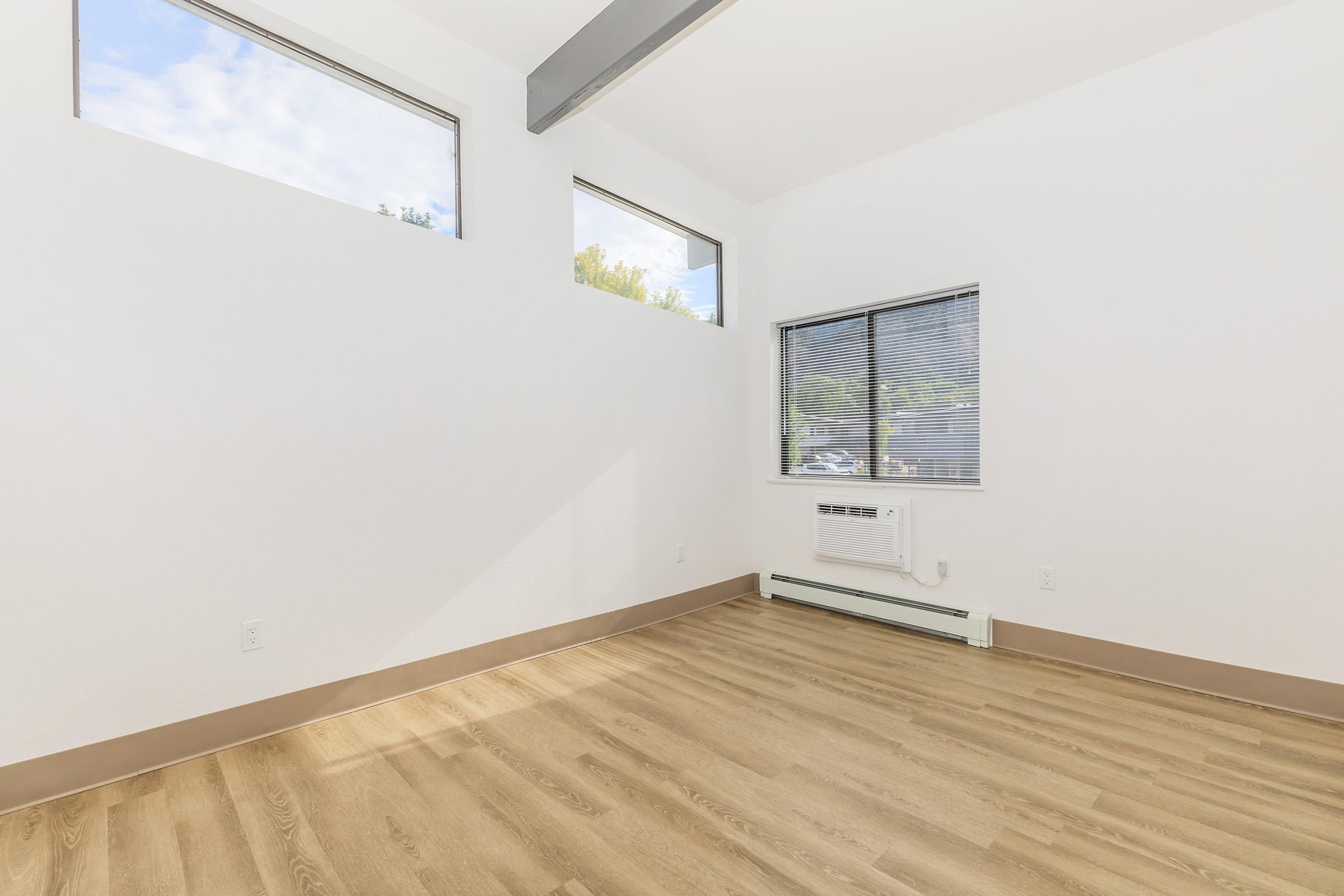 a bedroom with a wooden floor