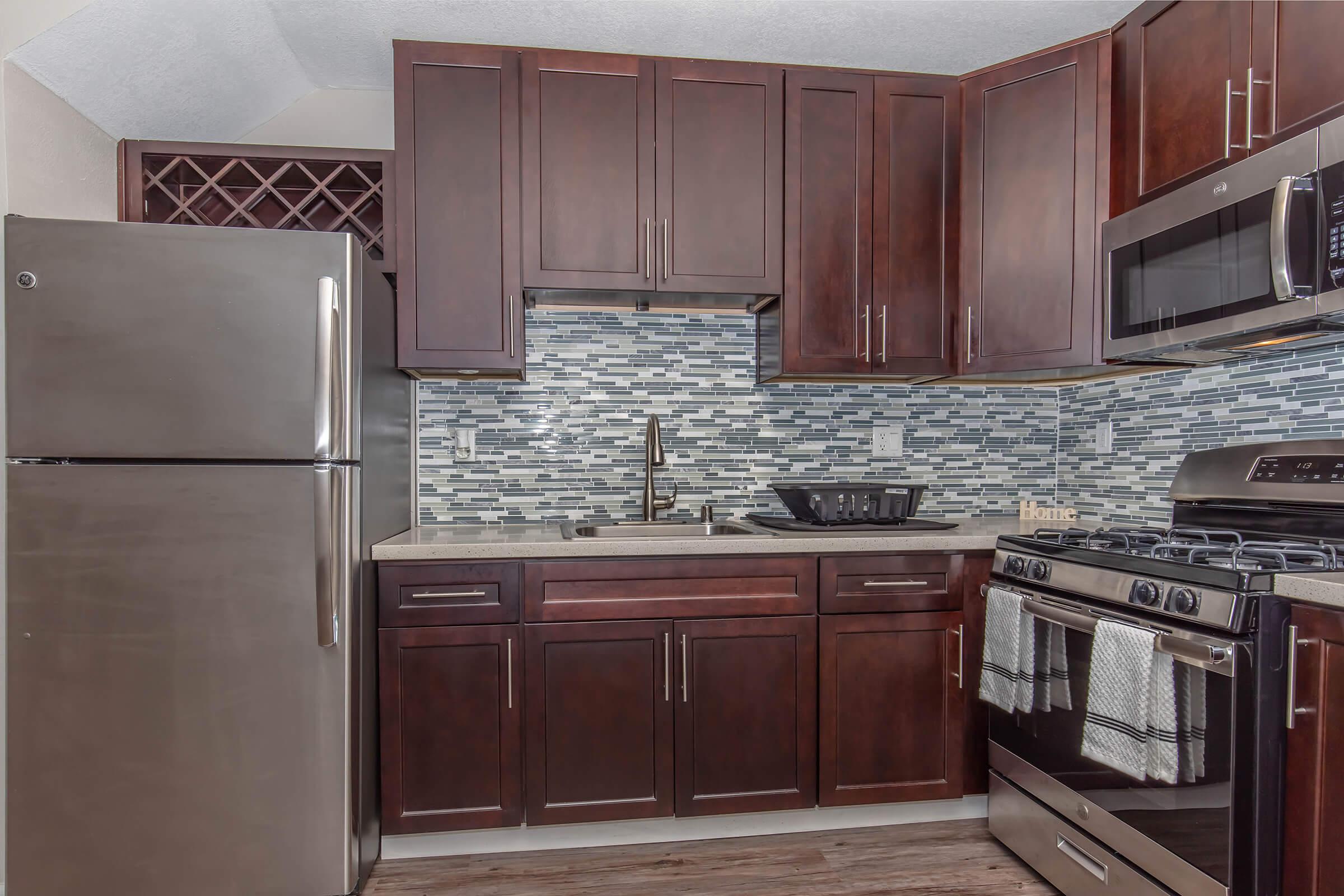 a kitchen with stainless steel appliances and wooden cabinets