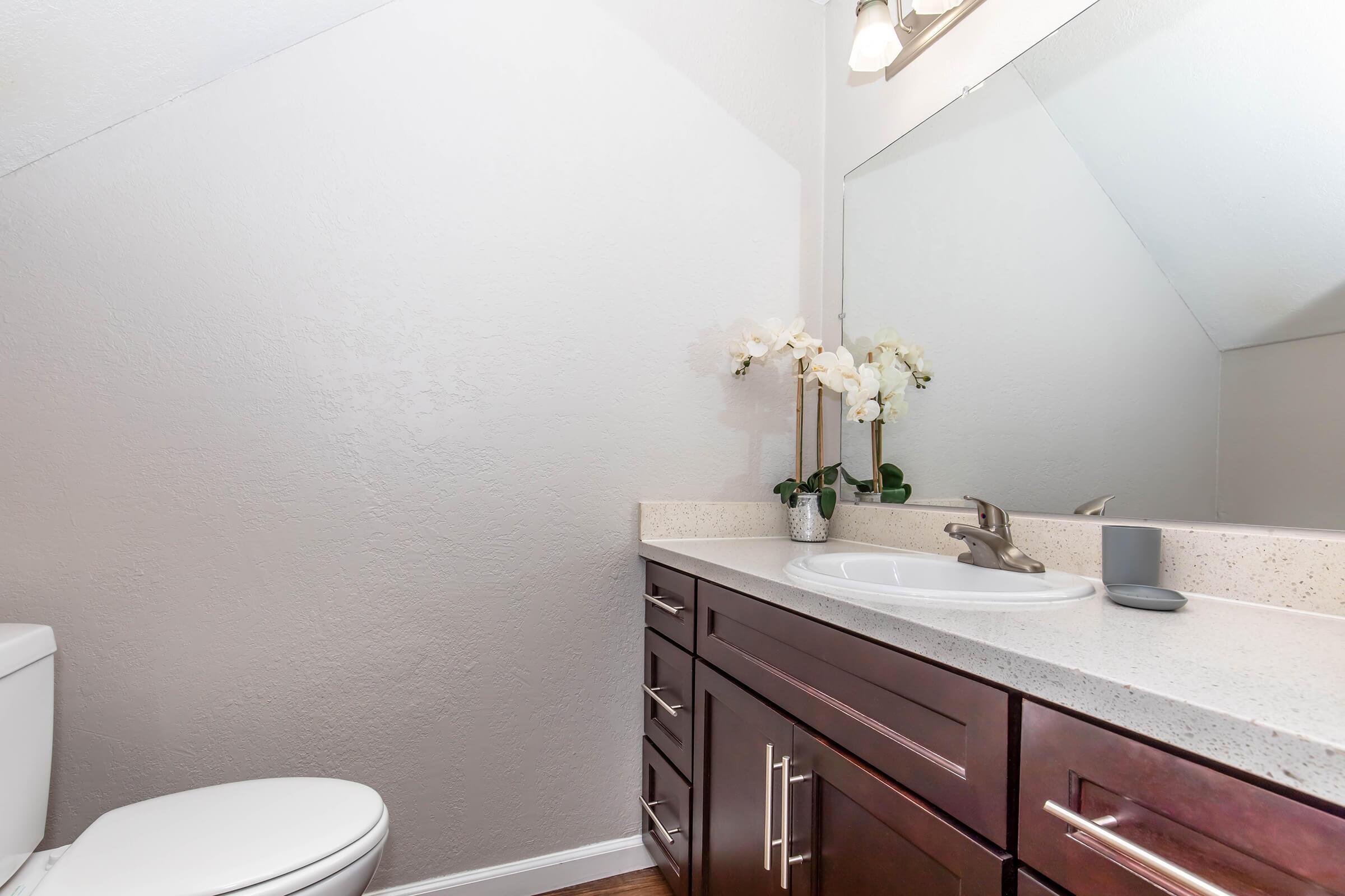 a kitchen with a sink and a mirror