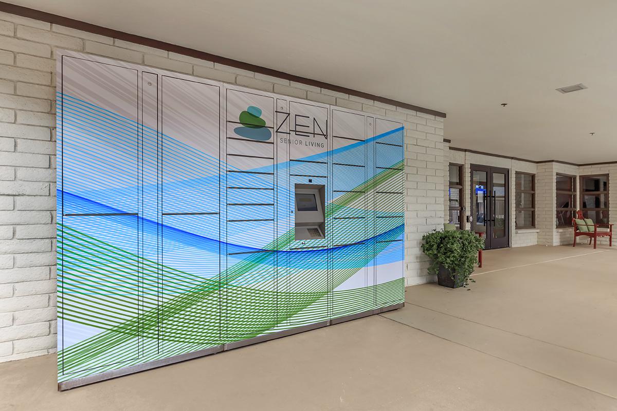 A decorative delivery locker unit with a colorful design featuring shades of blue and green, located outside a building entrance.