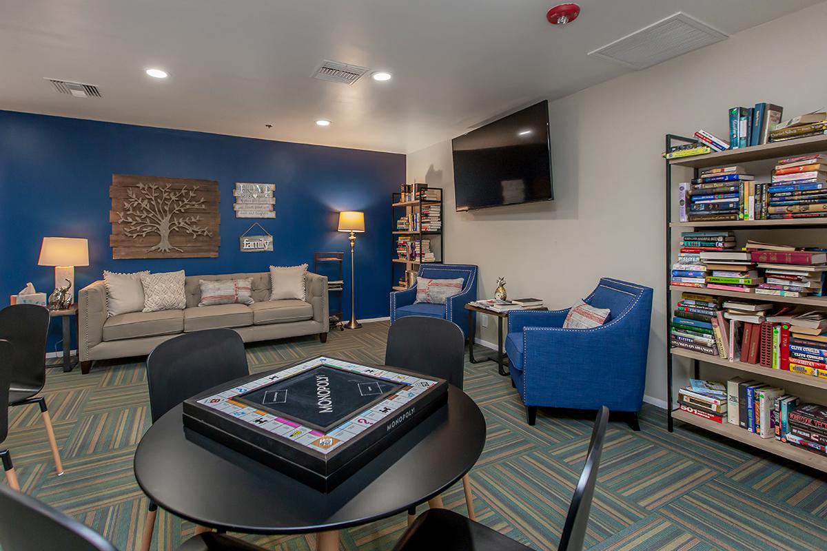 a living room filled with furniture and a flat screen tv