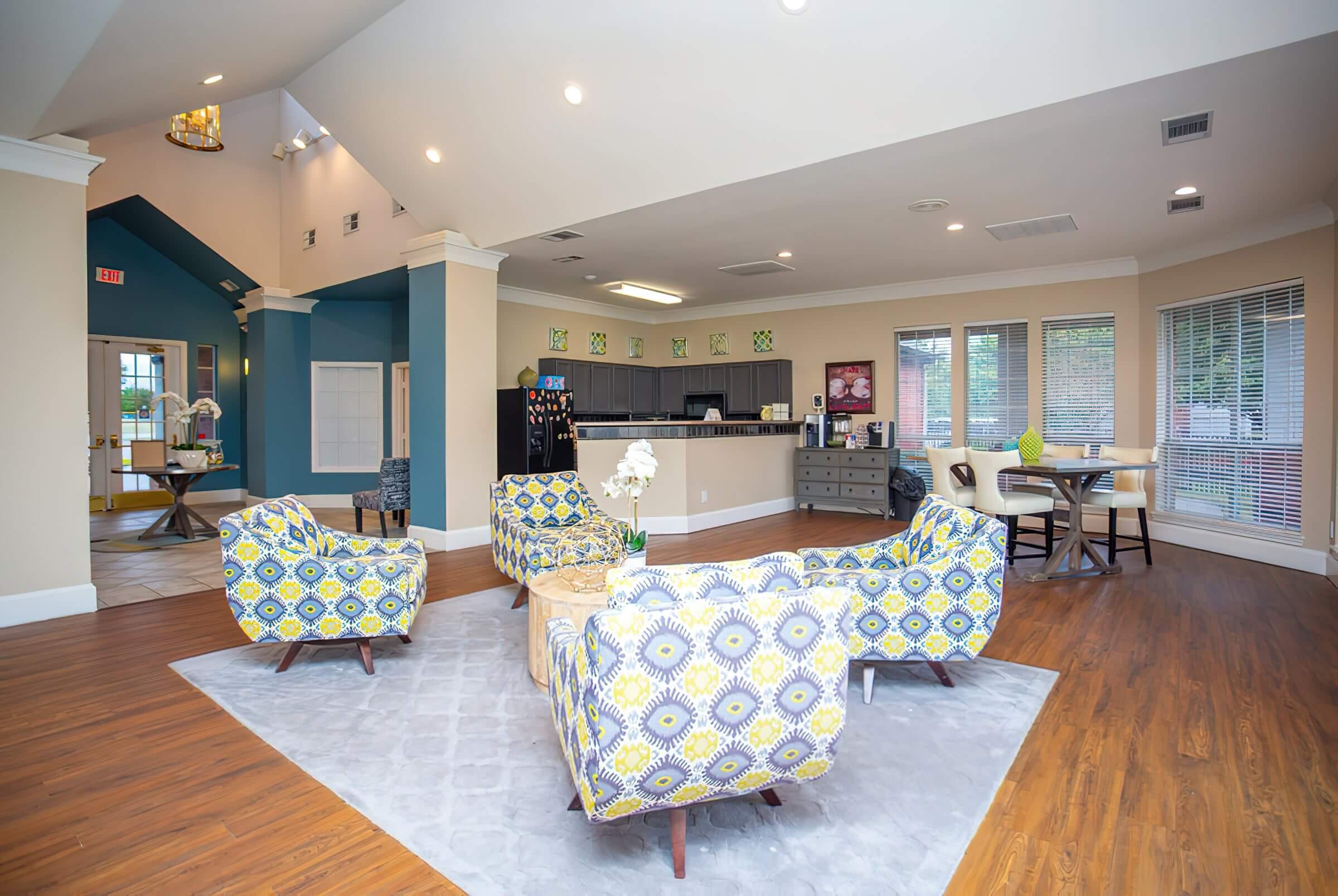 a living room filled with furniture on top of a hard wood floor