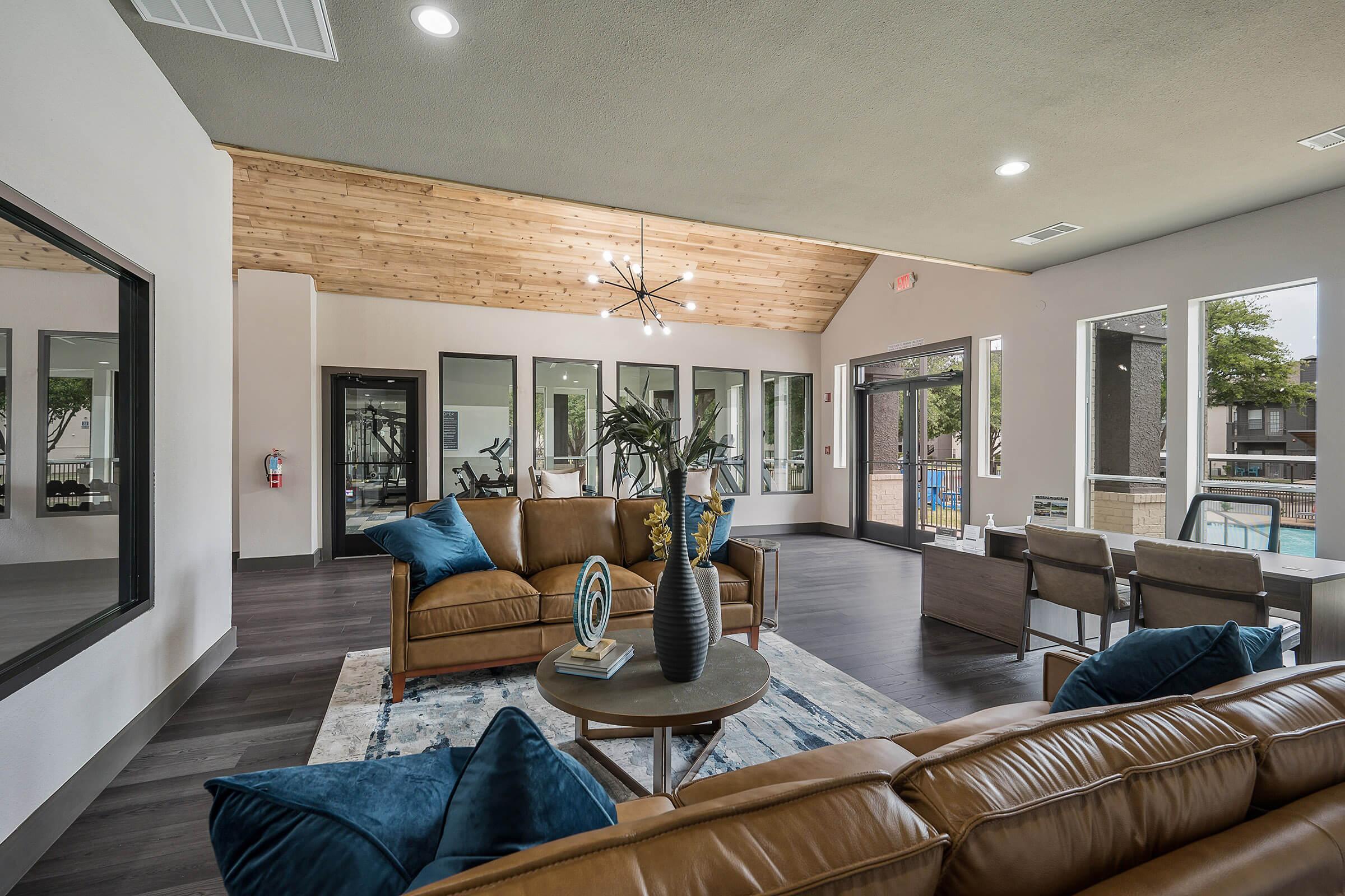 a living room filled with furniture and a large window