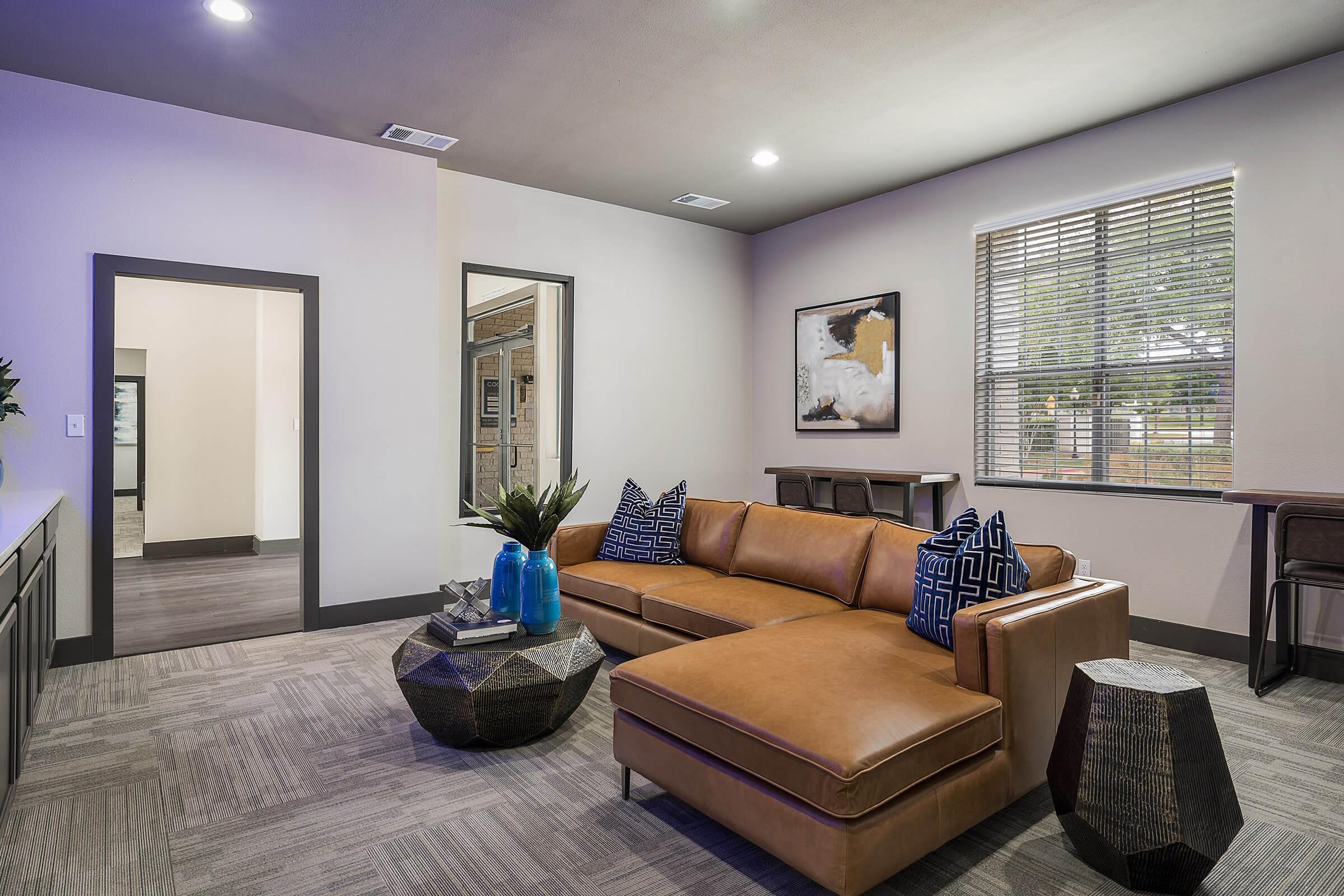 a living room filled with furniture and a large window