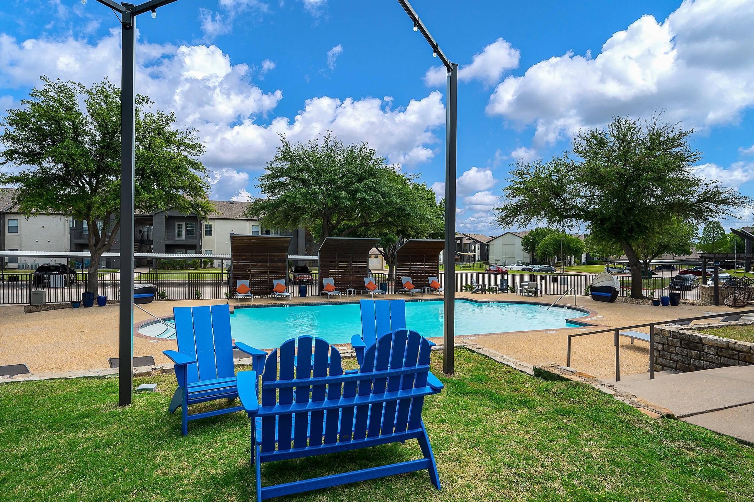 a couple of lawn chairs sitting on top of a blue bench