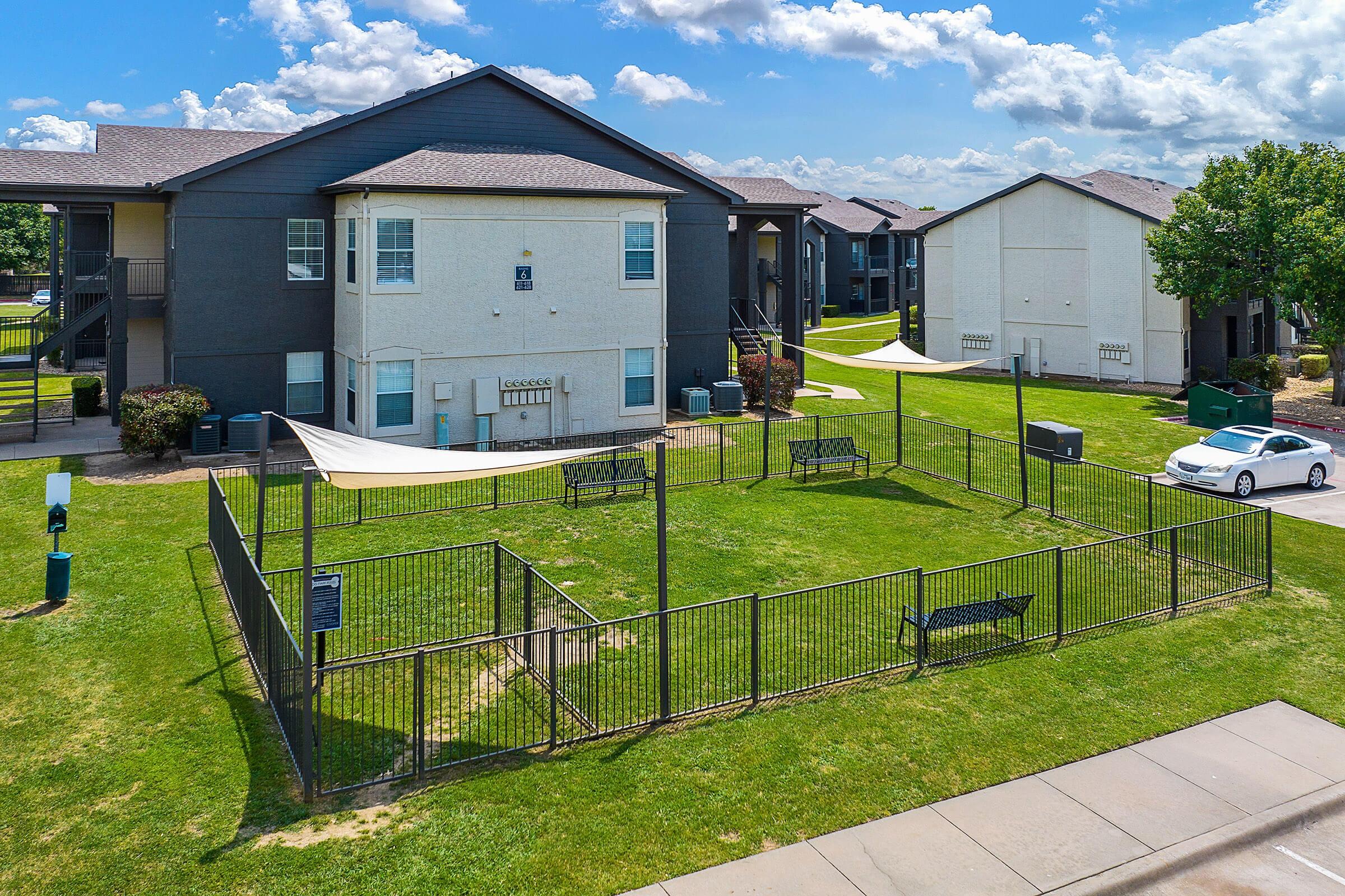 a house with a lawn in front of a building