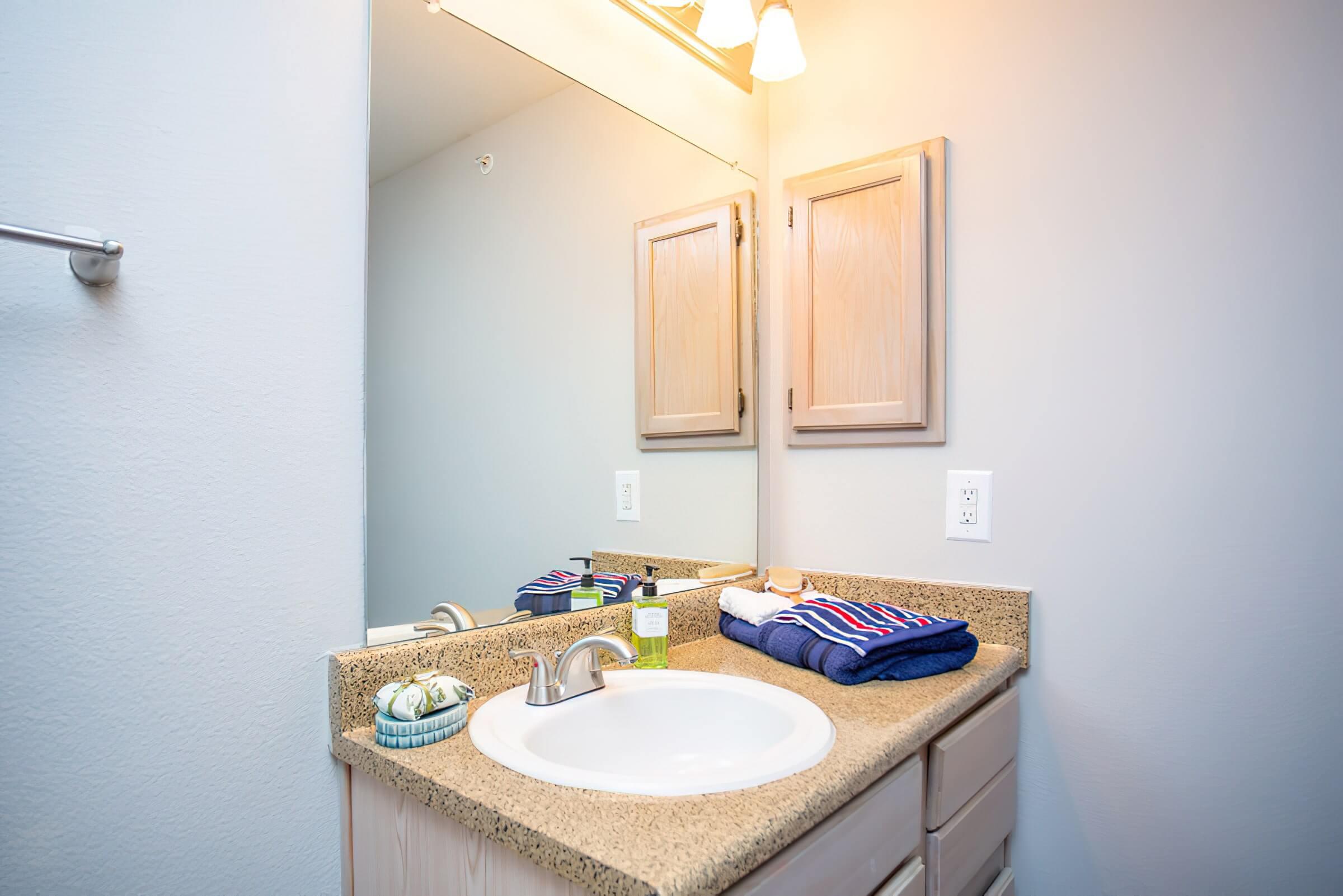 a room with a sink and a mirror